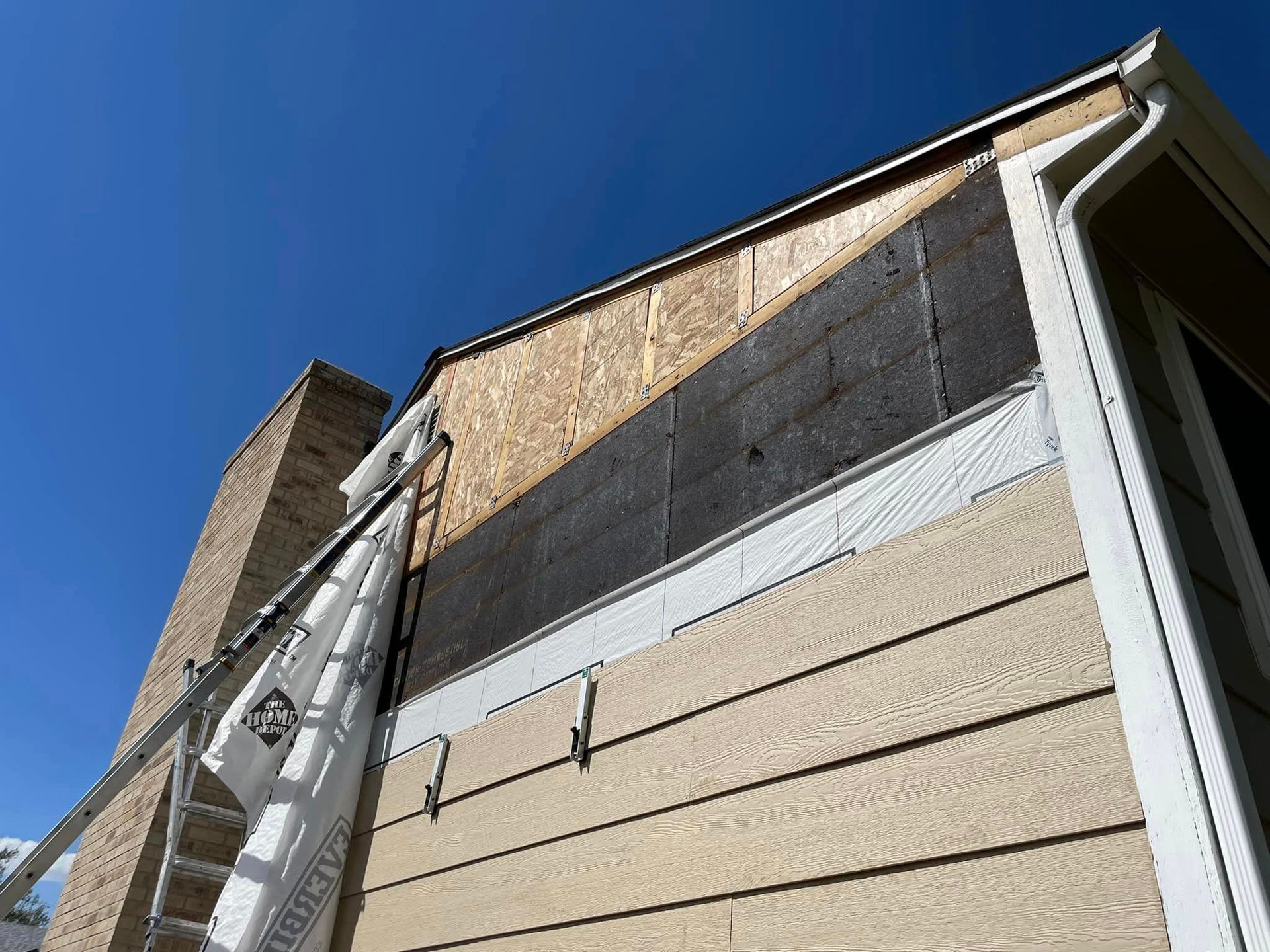 A ladder is attached to the side of a house.