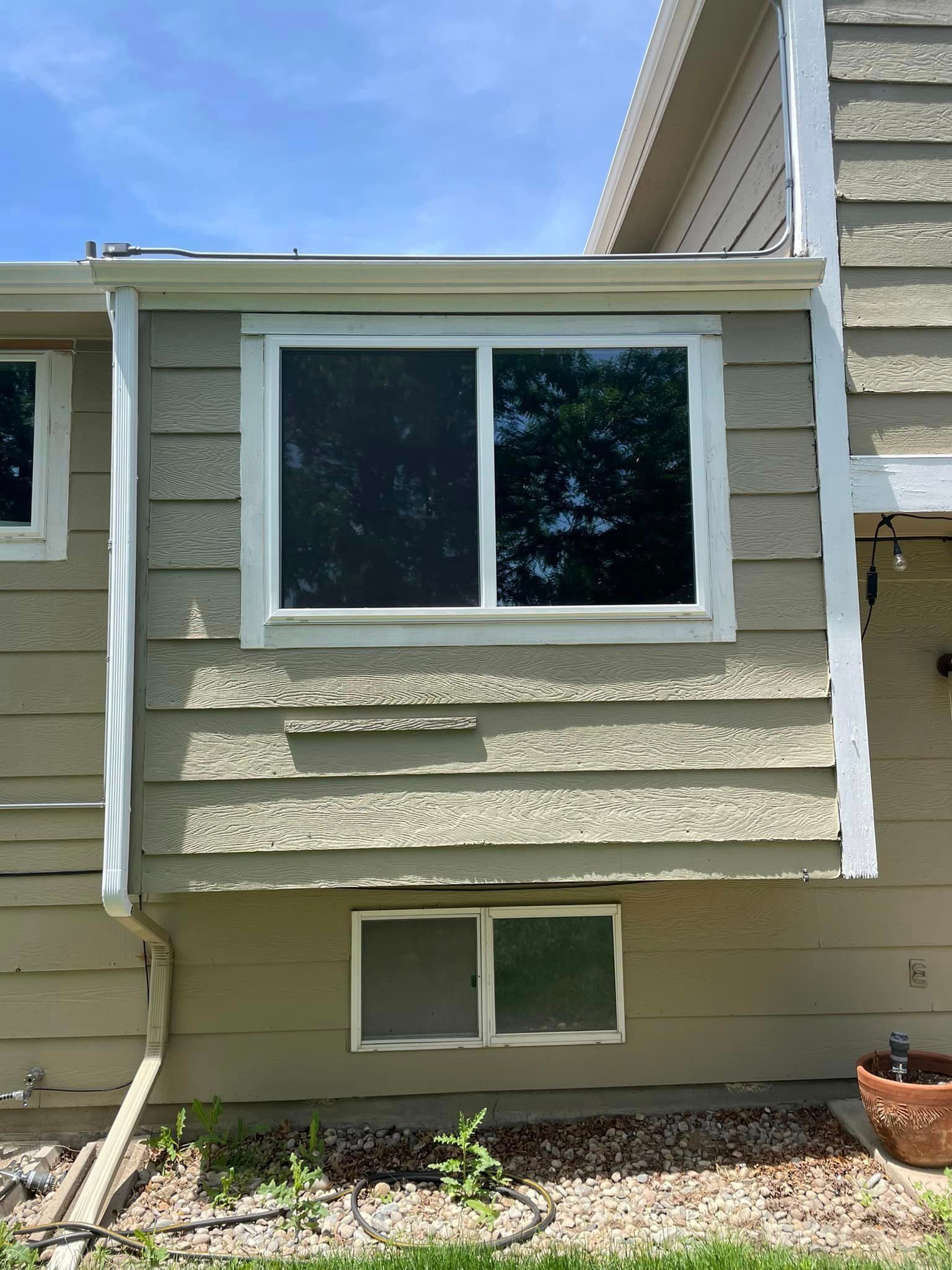 A house with a large window on the side of it.