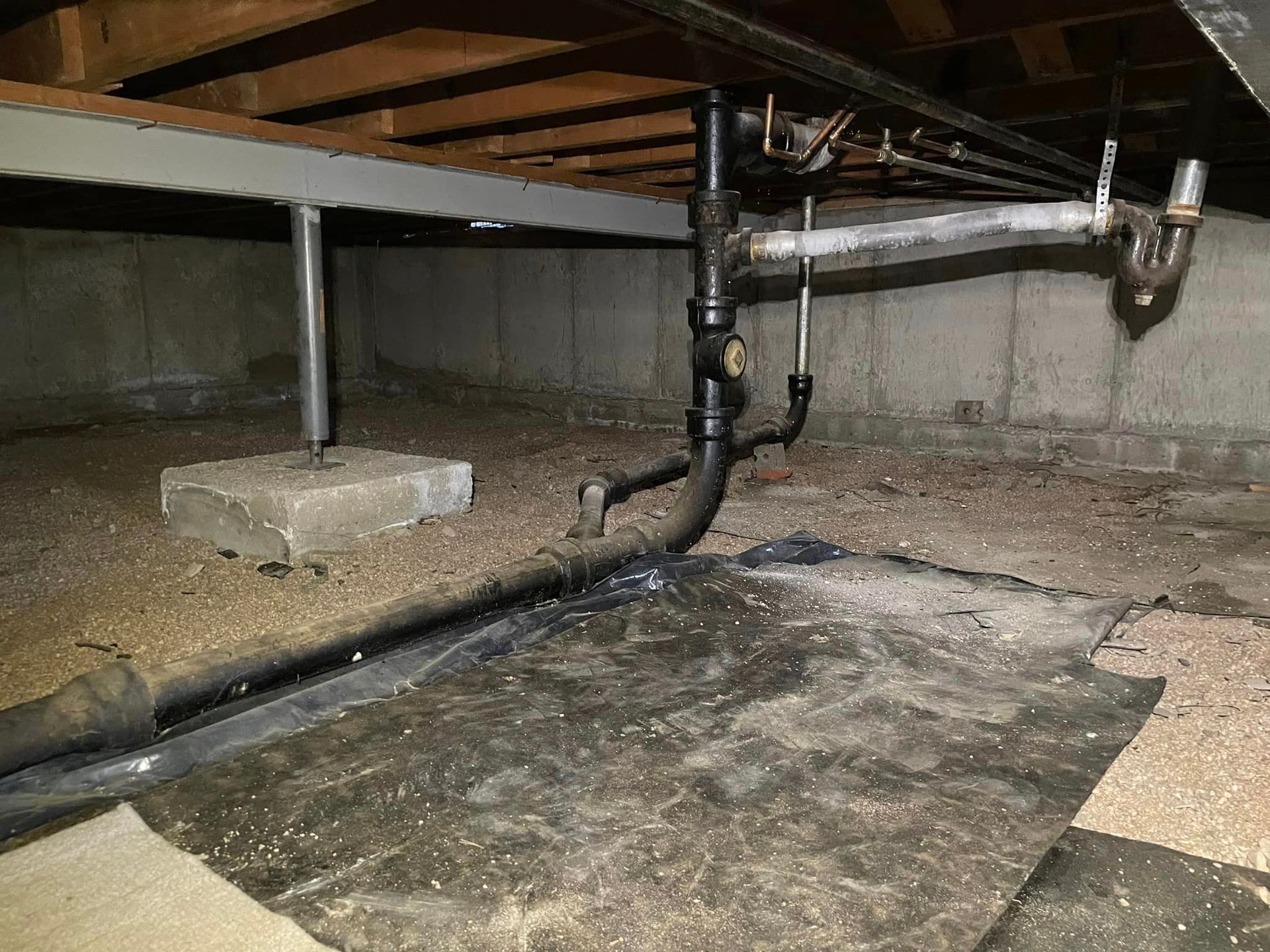 A basement with a lot of pipes coming out of it.