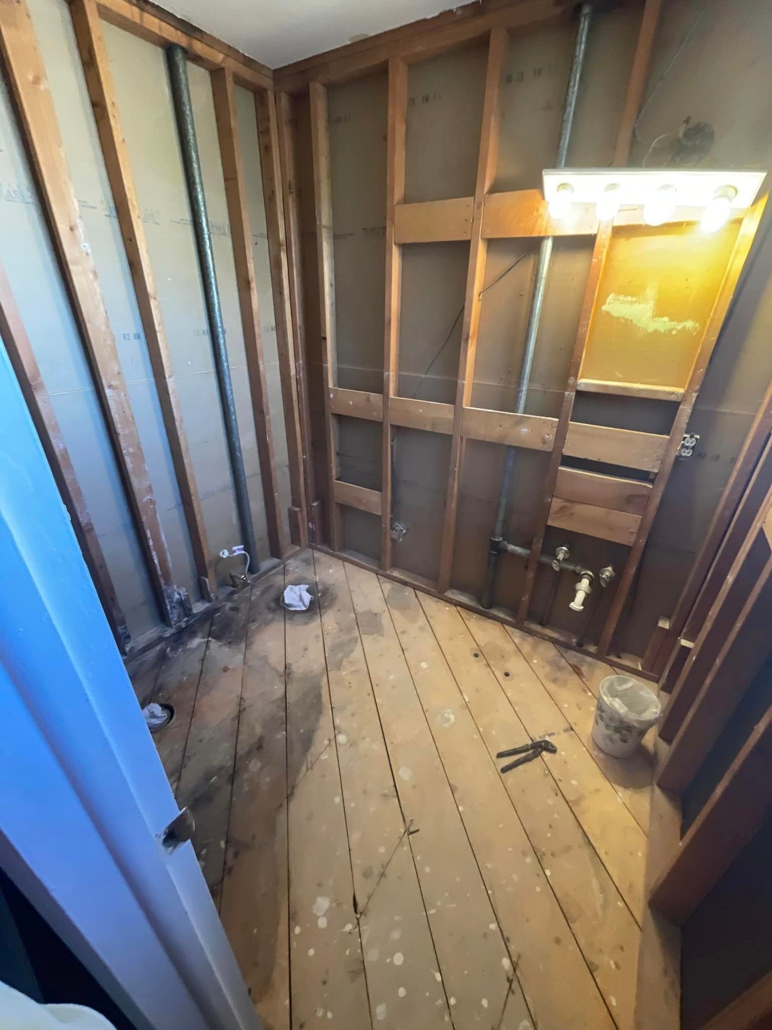 A room with wooden walls and a wooden floor is being remodeled.