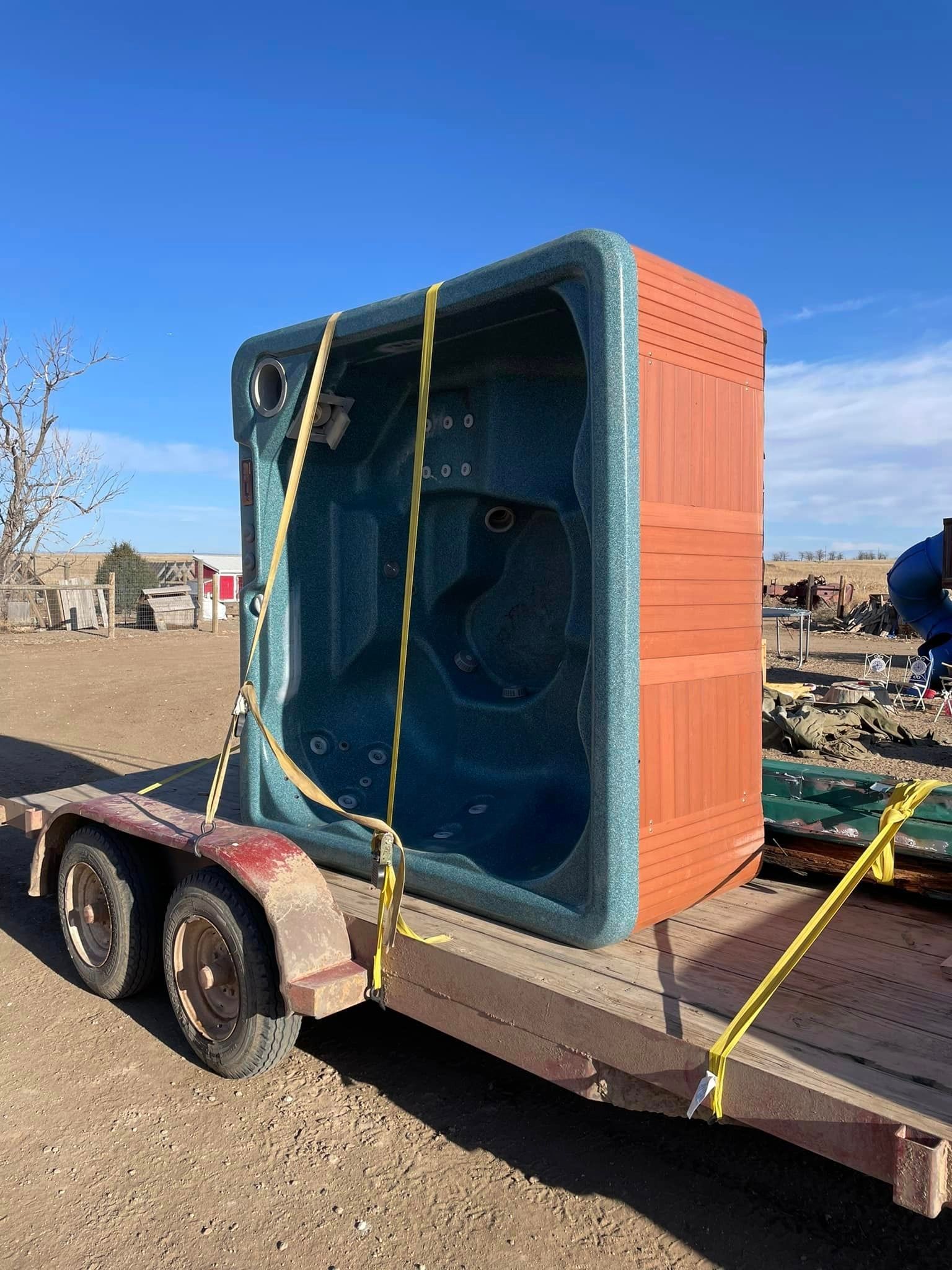 A hot tub is sitting on top of a trailer.