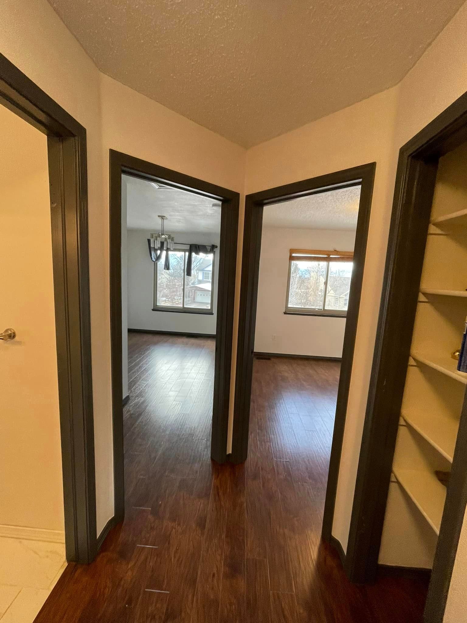 A hallway leading to a living room and a closet