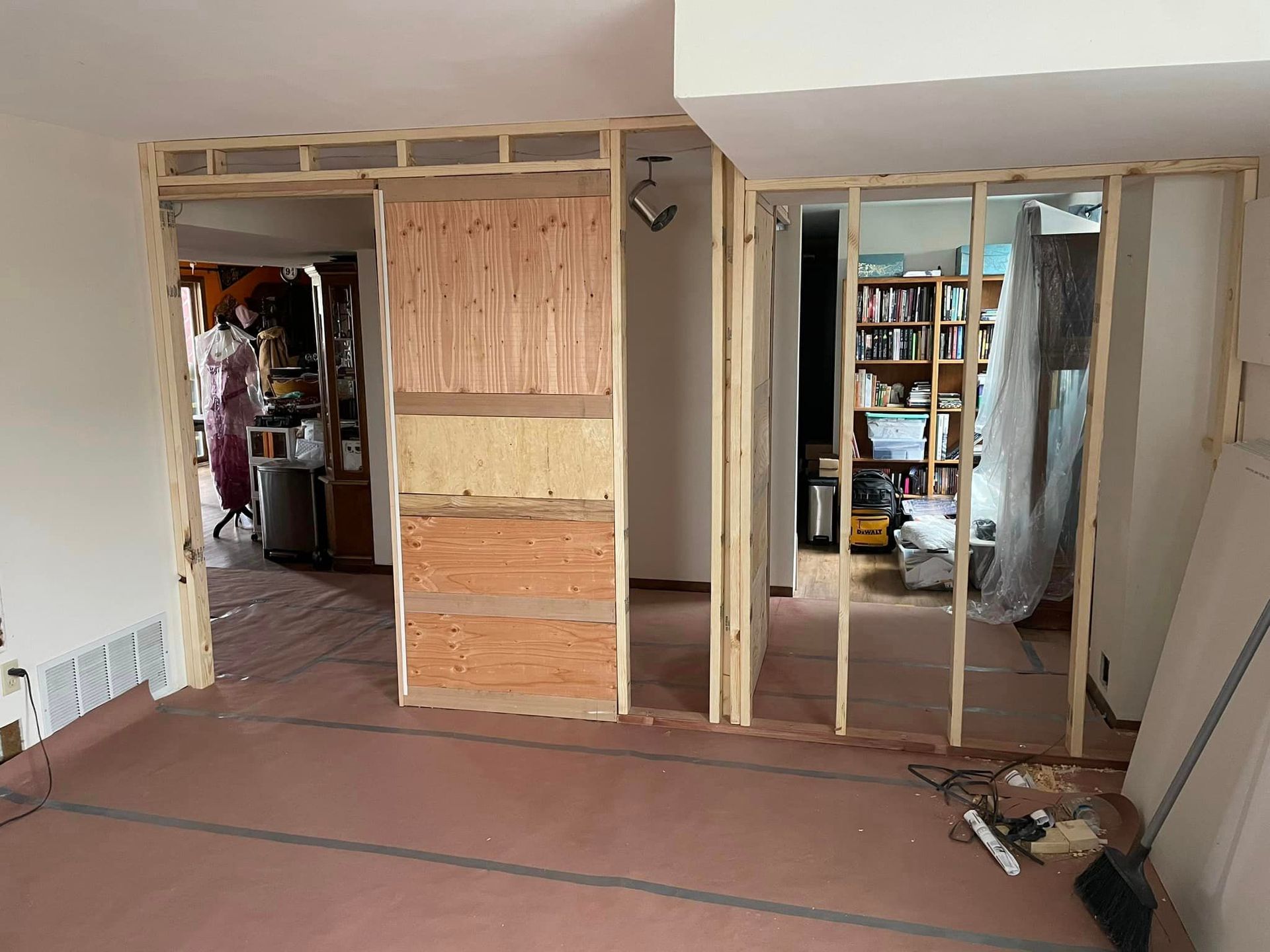 A room with a wooden wall being built in a house.