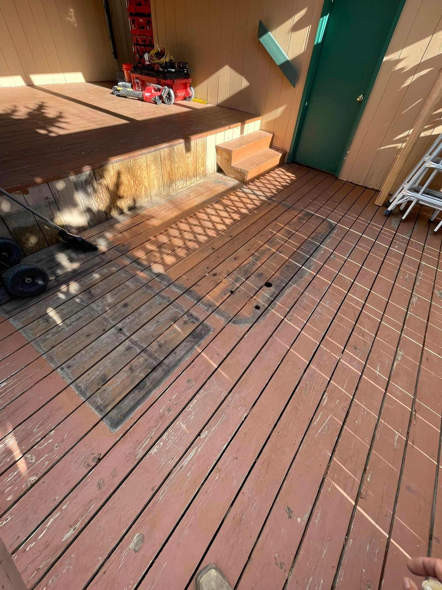 A person is standing on a wooden deck.