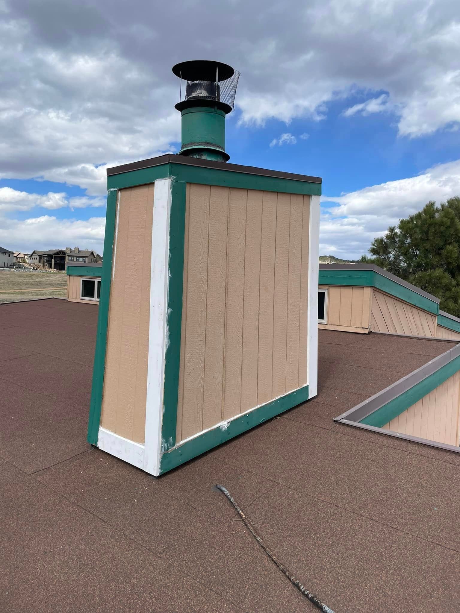 A chimney is sitting on top of a roof.