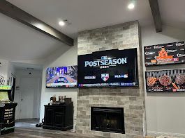 A living room with a fireplace and a flat screen tv.