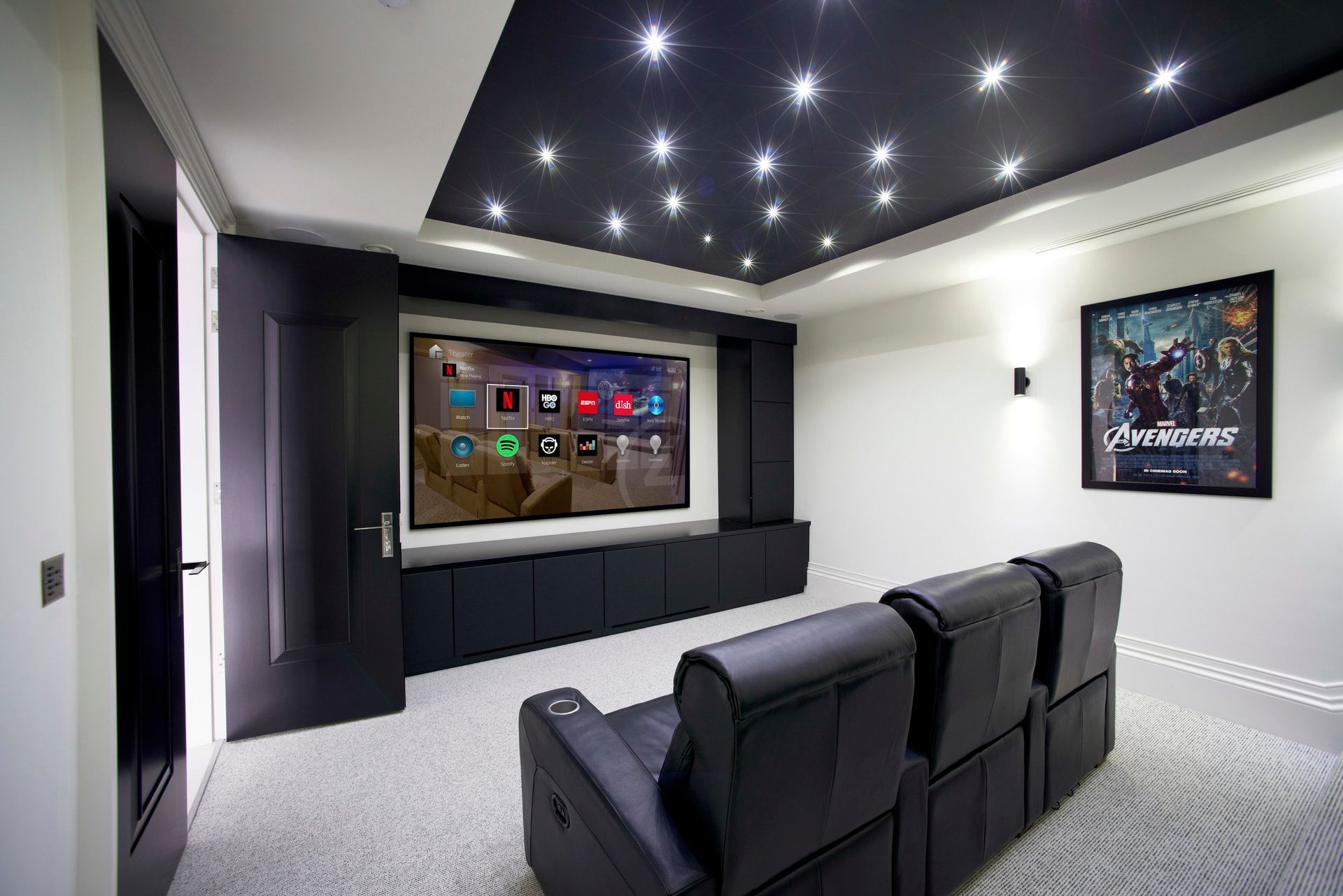 A home theater with a couch and a flat screen tv. Portfolio for Premier Lighting & Home Automation in Dallas Fort Worth (DFW).