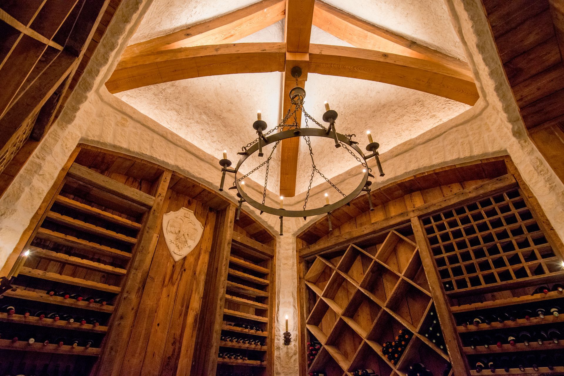 A wine cellar with a chandelier hanging from the ceiling.