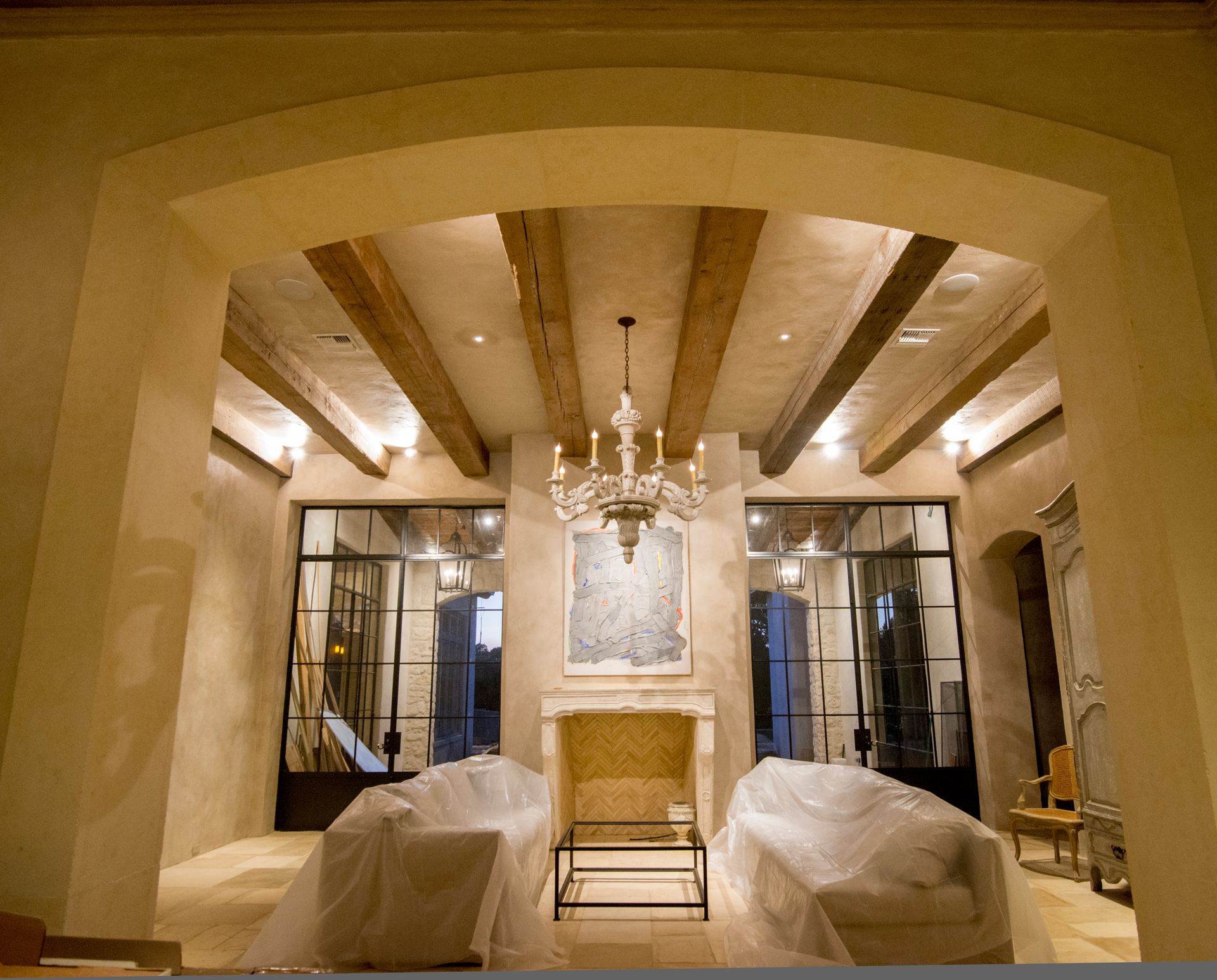 A living room with a fireplace and a chandelier. Portfolio for Premier Lighting & Home Automation in Dallas Fort Worth (DFW).