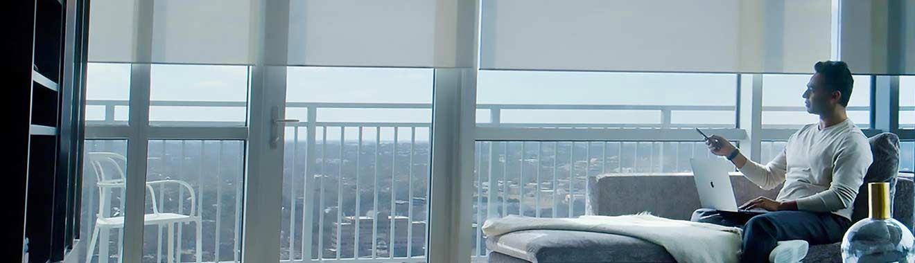 A man is using a tablet to control a thermostat. Portfolio for Premier Lighting & Home Automation home automation Dallas automation systems.