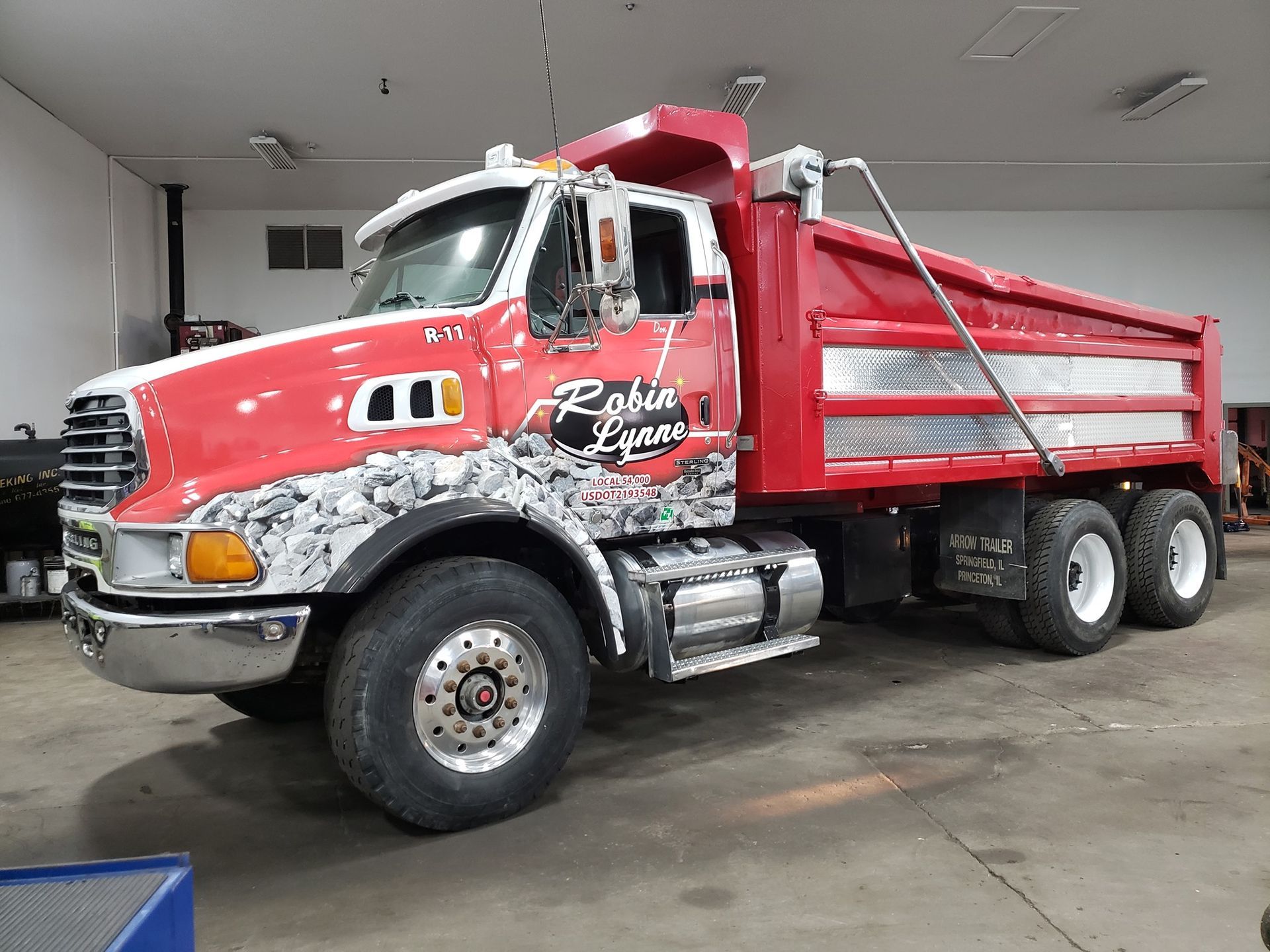 Yellow excavator digging dirt on a construction site under a blue sky.