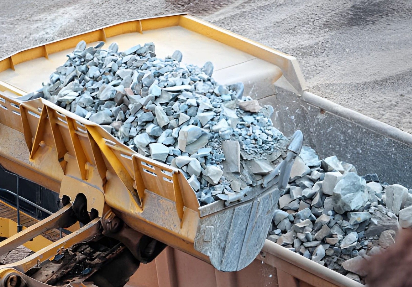 Asphalt paving truck laying down fresh pavement on a rural road, worker watches.