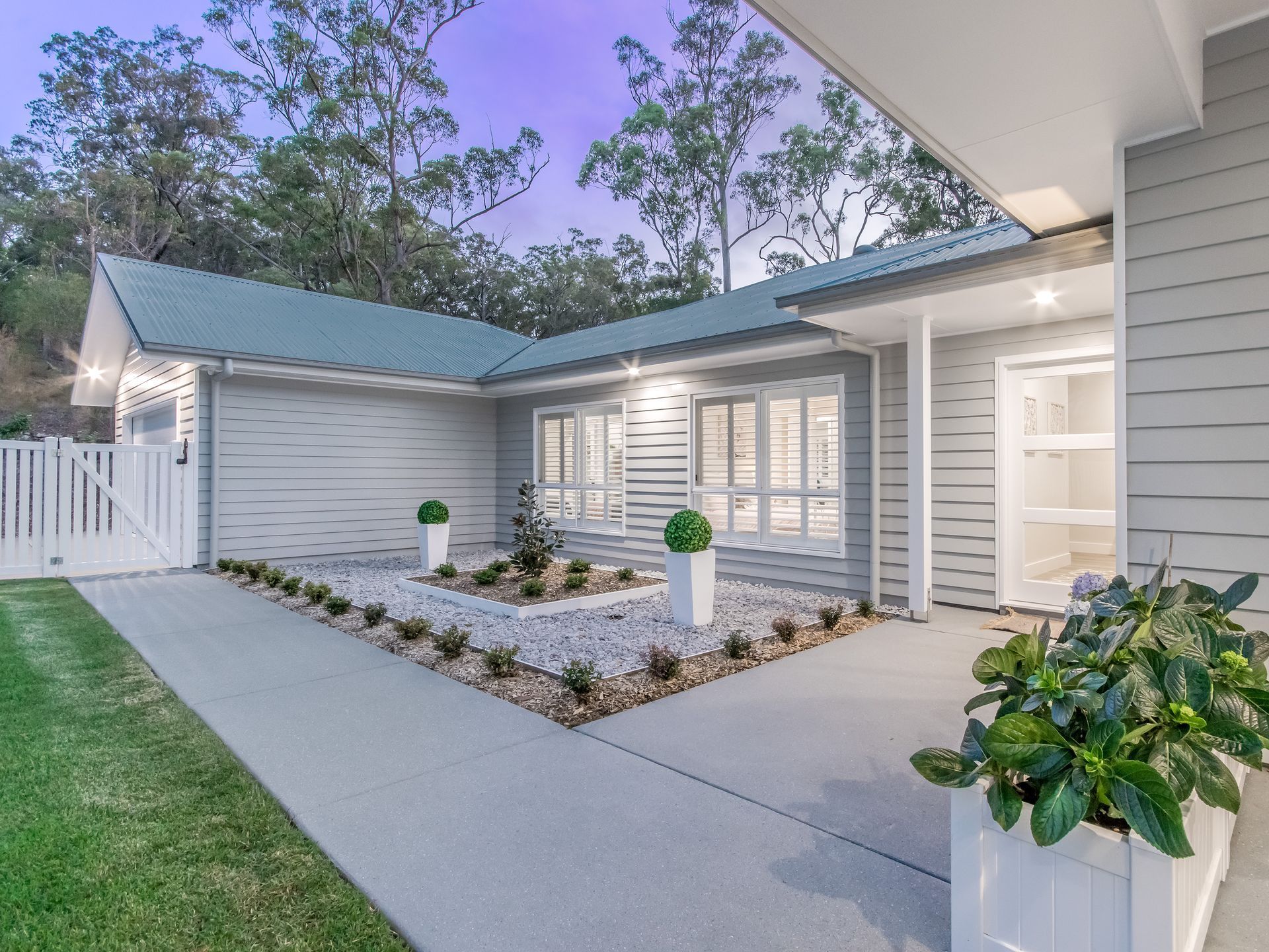 A Modern, Light Gray House Exterior With a Green Tiled Roof — Michael Duncan Constructions Pty Ltd in Robina, QLD