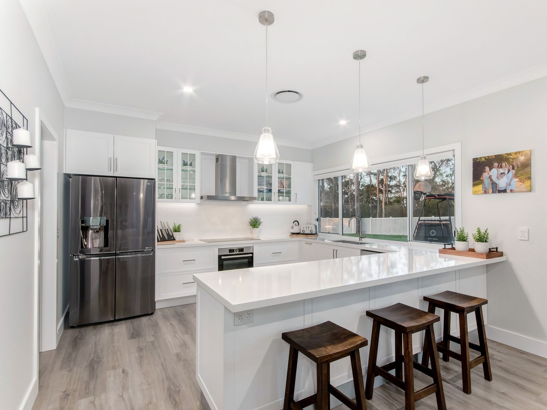 A Modern Kitchen With White Cabinets — Michael Duncan Constructions Pty Ltd in Robina, QLD
