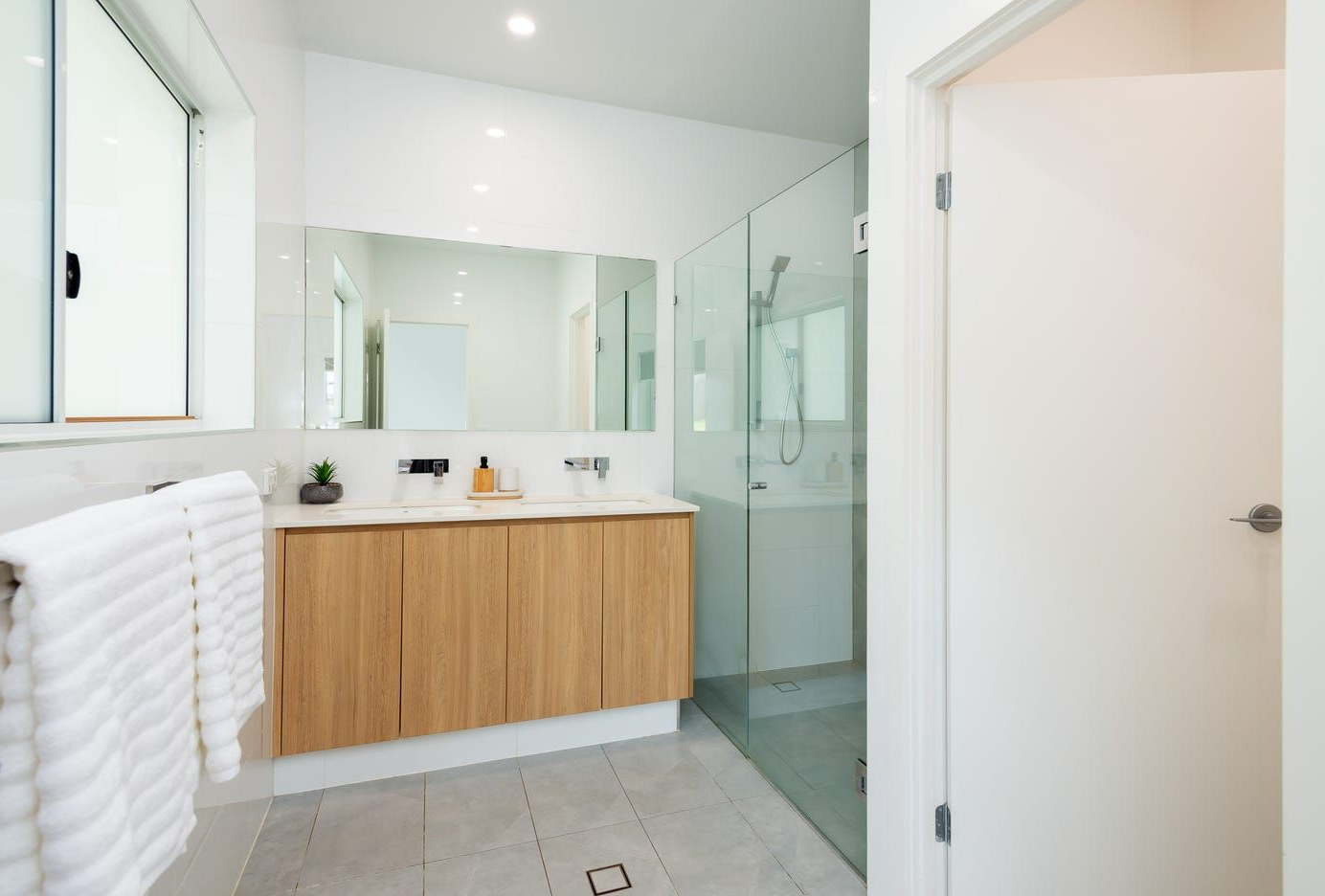 A Modern, Bright Bathroom With a Light Wood Vanity — Michael Duncan Constructions Pty Ltd in Ashmore, QLD
