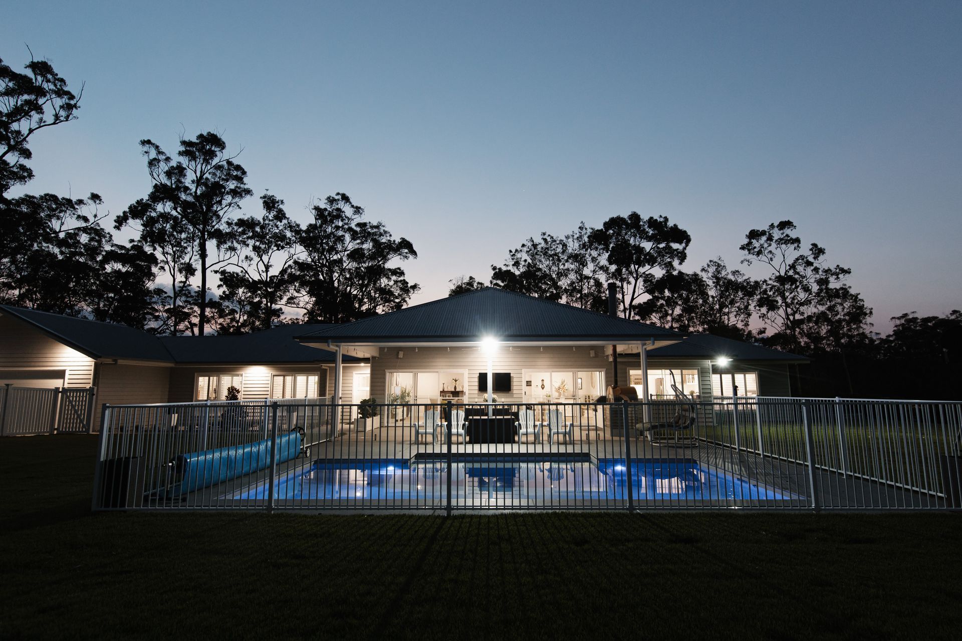 A Modern House With a Pool at Dusk — Michael Duncan Constructions Pty Ltd in Robina, QLD
