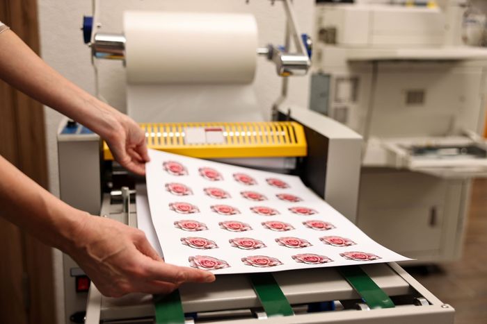 A person is putting a piece of paper into a machine.