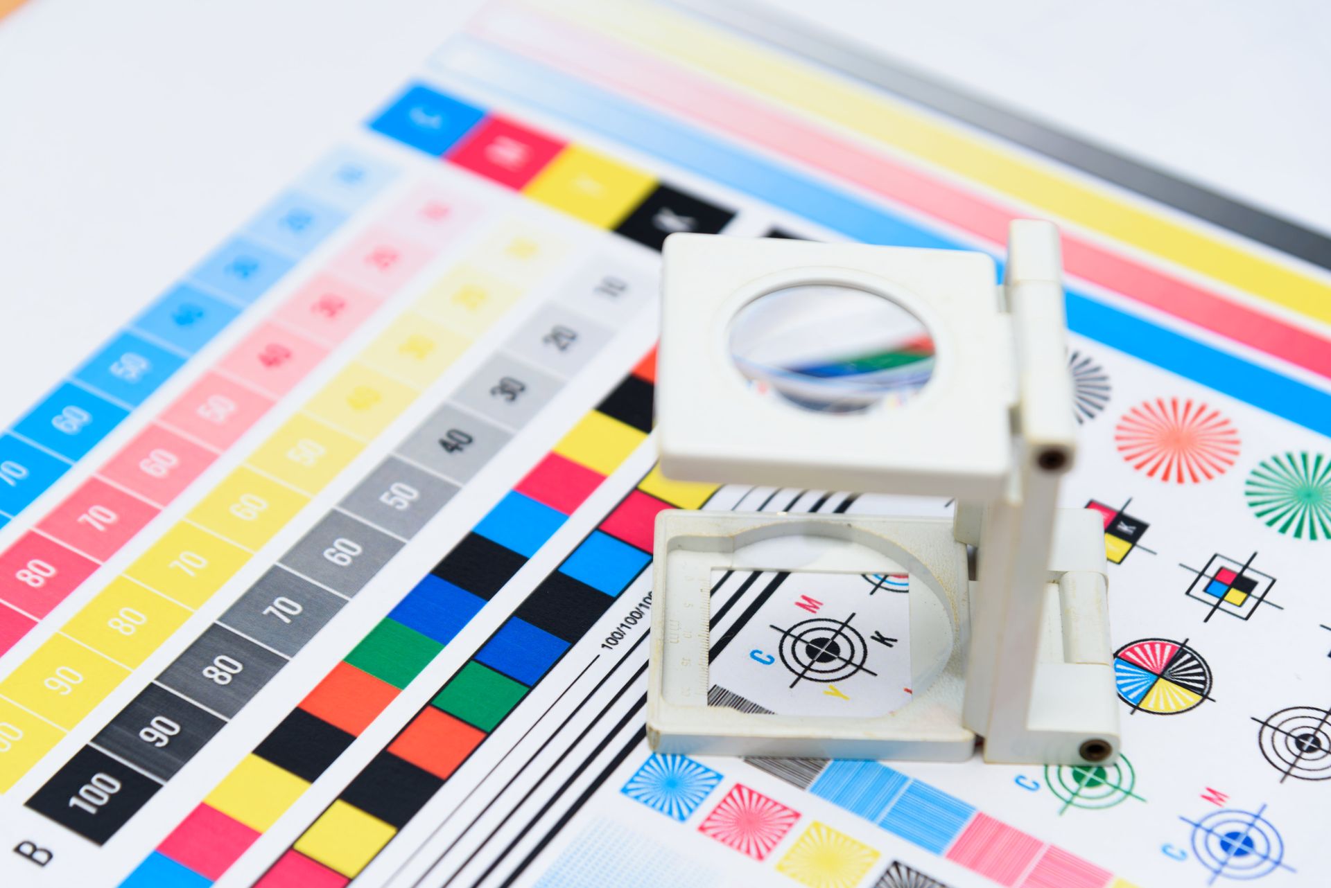 A magnifying glass is sitting on top of a sheet of paper.