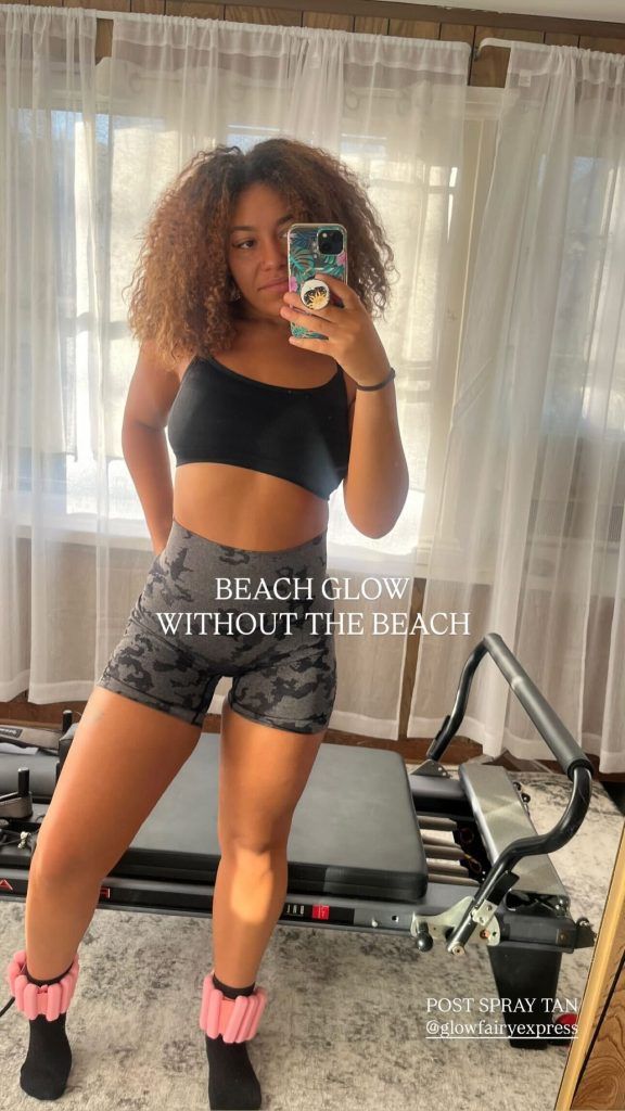 Woman in workout clothes holding phone, next to Pilates machine. Text: 