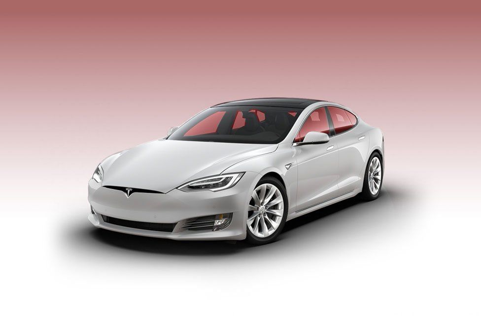White Tesla Model S sedan, on a white and red gradient background.