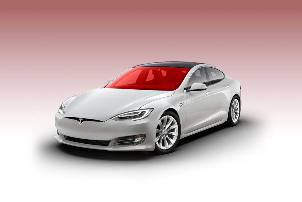 White Tesla car with red tinted windows on a gradient background.