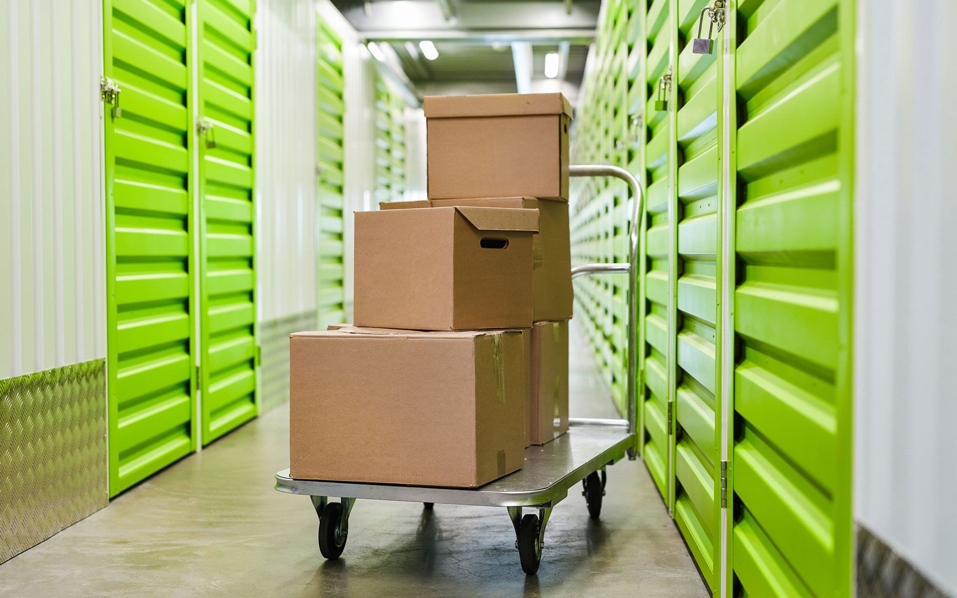 A cart filled with cardboard boxes in a storage room.