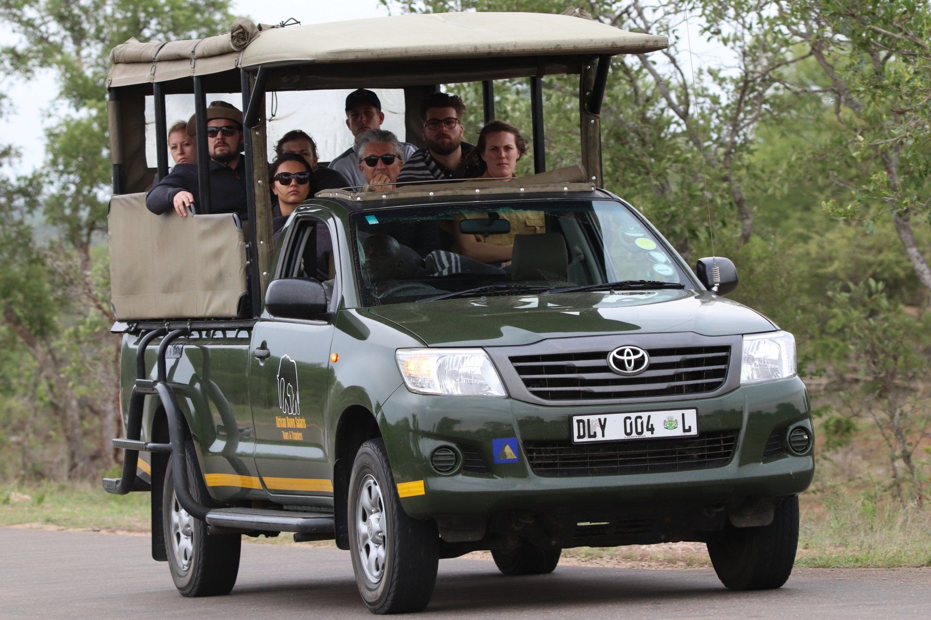 A group of people are riding in a toyota hilux pickup truck.