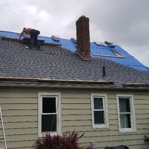 A Man Is Working On The Roof Of A House - Ravenna, Ohio - PRCA