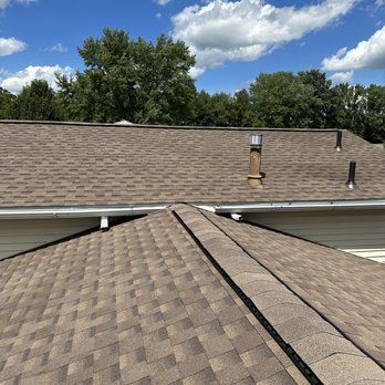 A Roof With A Chimney On It And A Blue Sky In The Background - Ravenna, Ohio - PRCA
