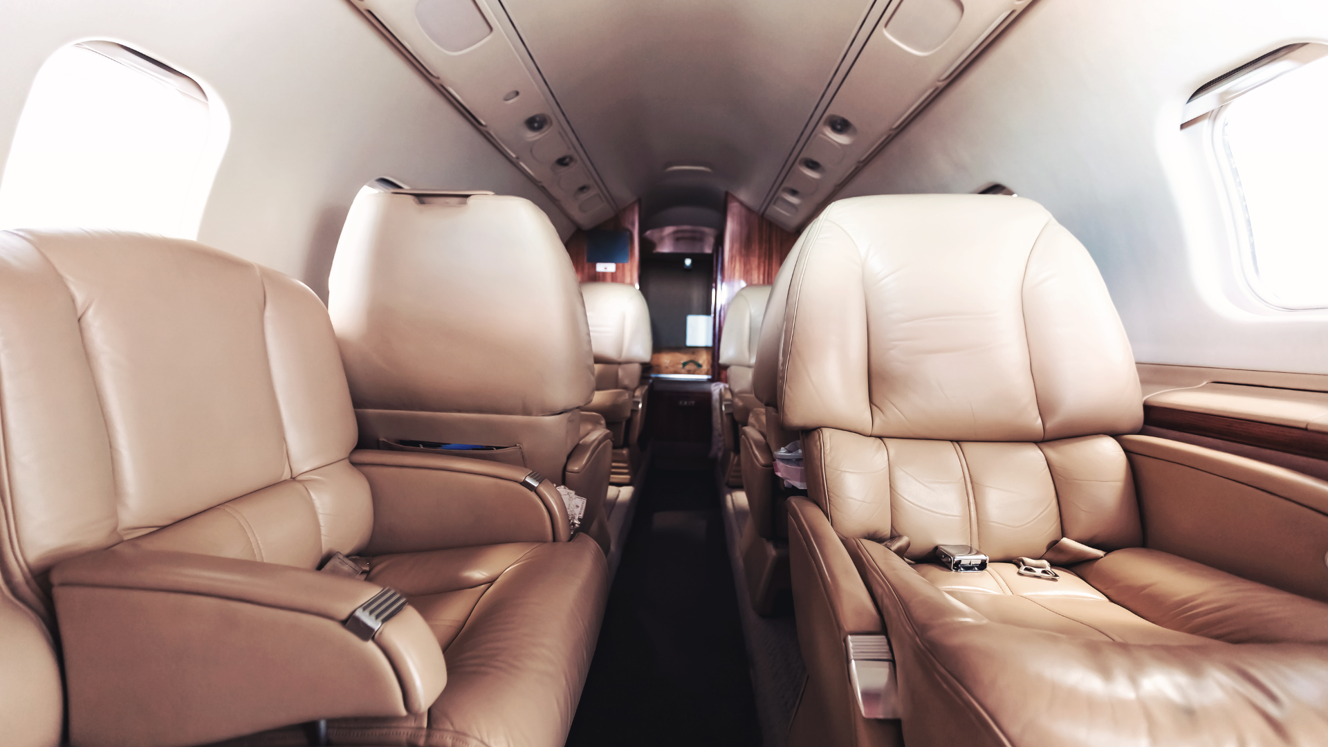 The inside of a private jet with a lot of seats