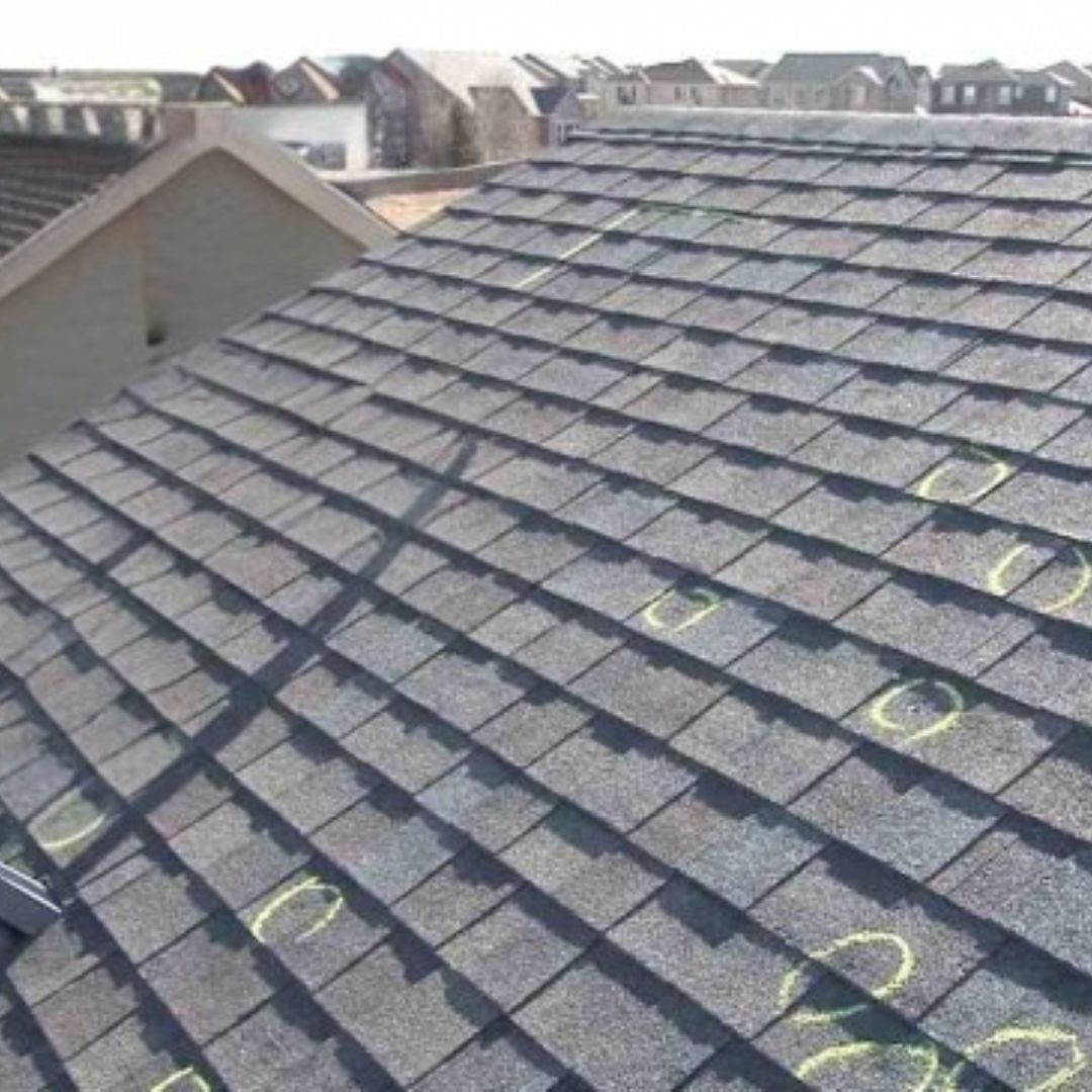 Hail damage marked on asphalt shingles during a professional roof inspection in Middle Georgia
