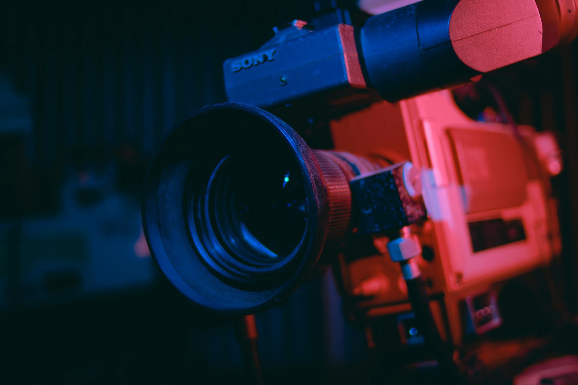 Close-up of a Sony camcorder, illuminated with blue and red light.