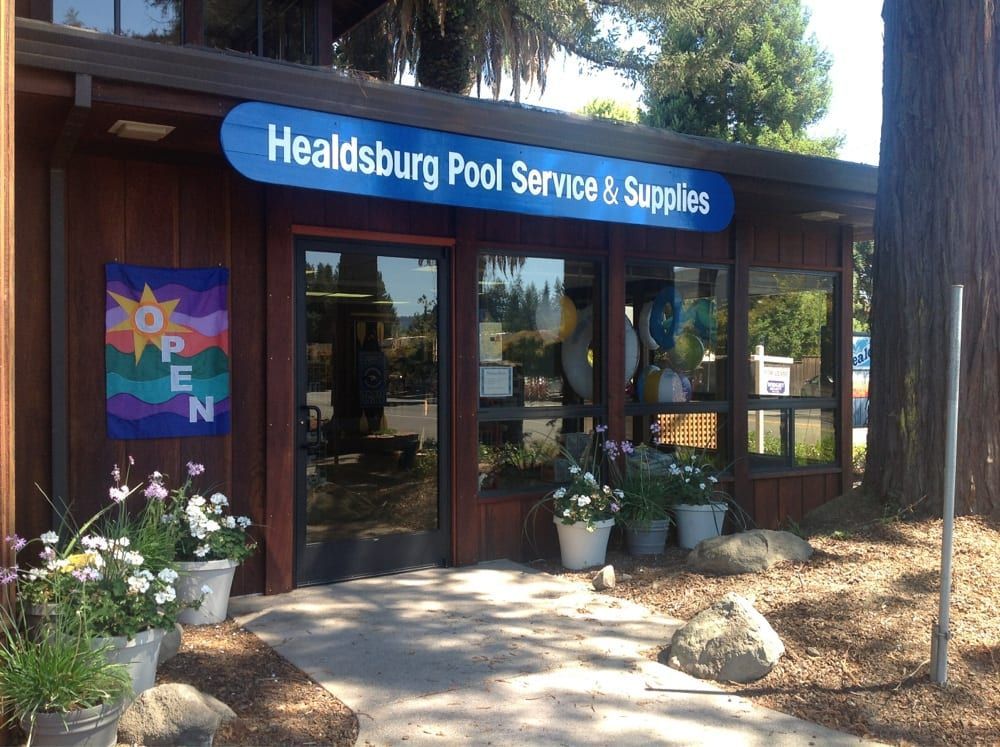 Healdsburg Pool Service & Supplies storefront with glass doors, potted plants, and an open sign