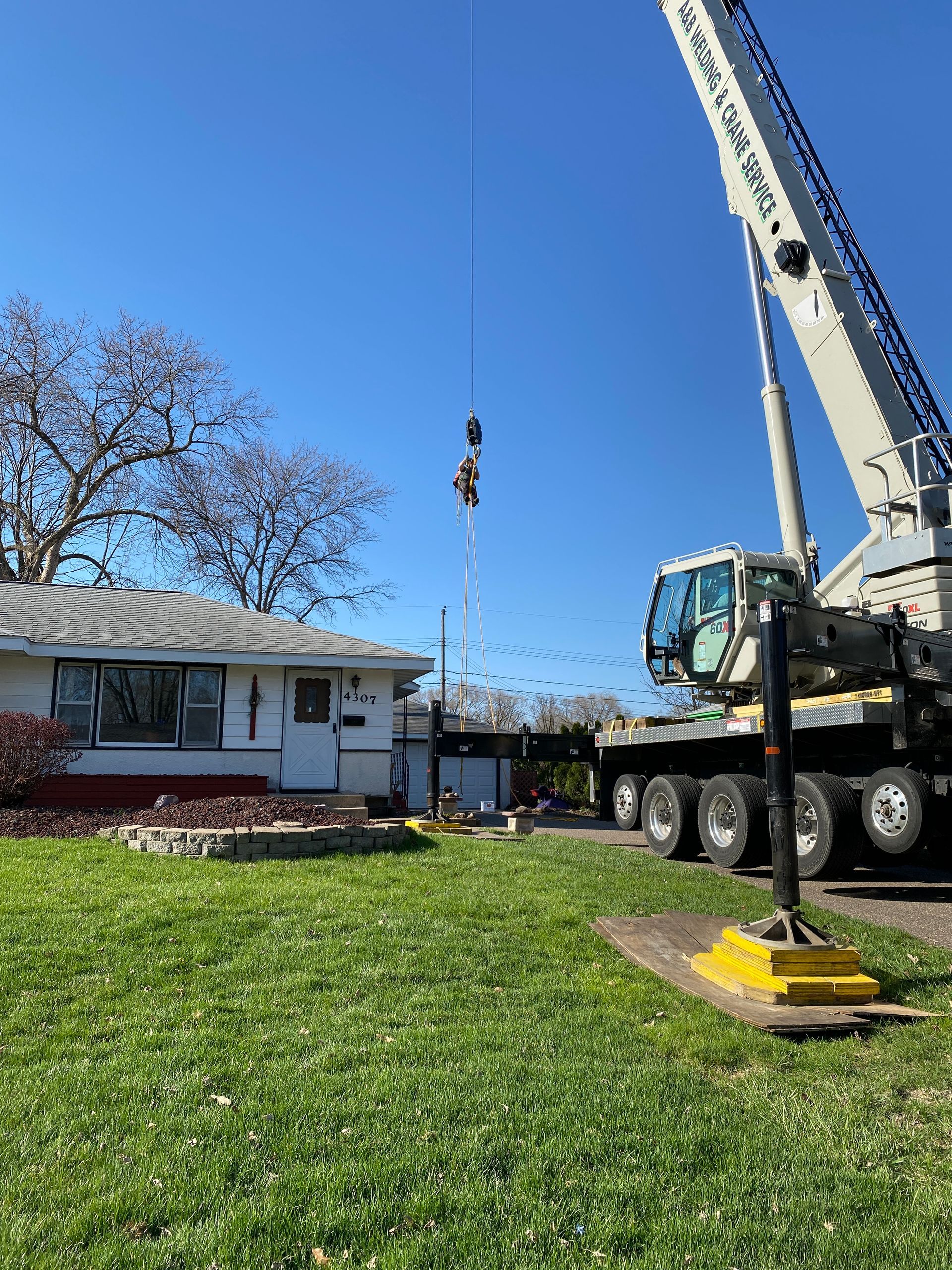 A Large Crane is Sitting in front of a House  | Minneapolis, MN | Arbor Tree Service