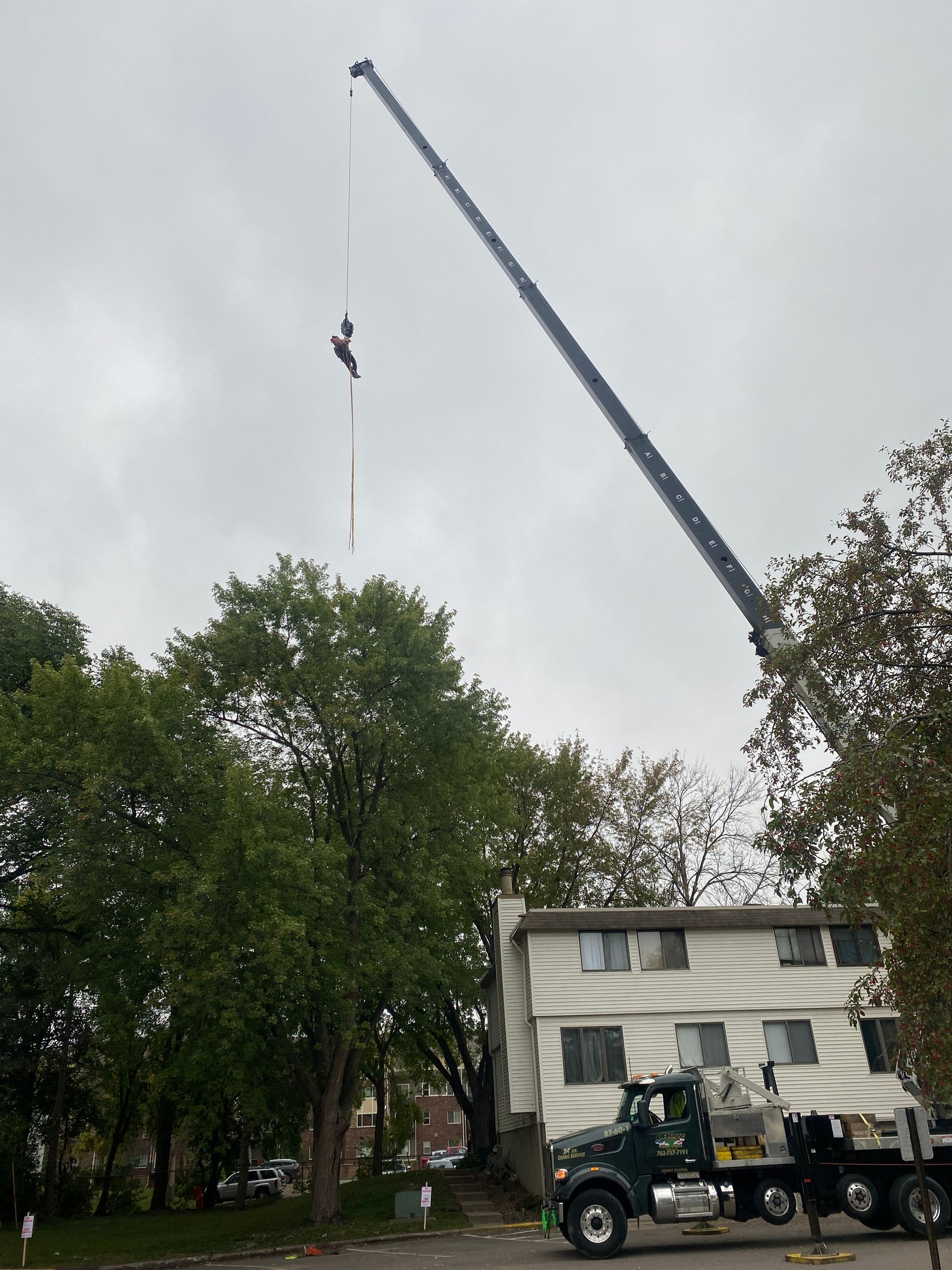 A Crane in Front of a House | Minneapolis, MN | Arbor Tree Service