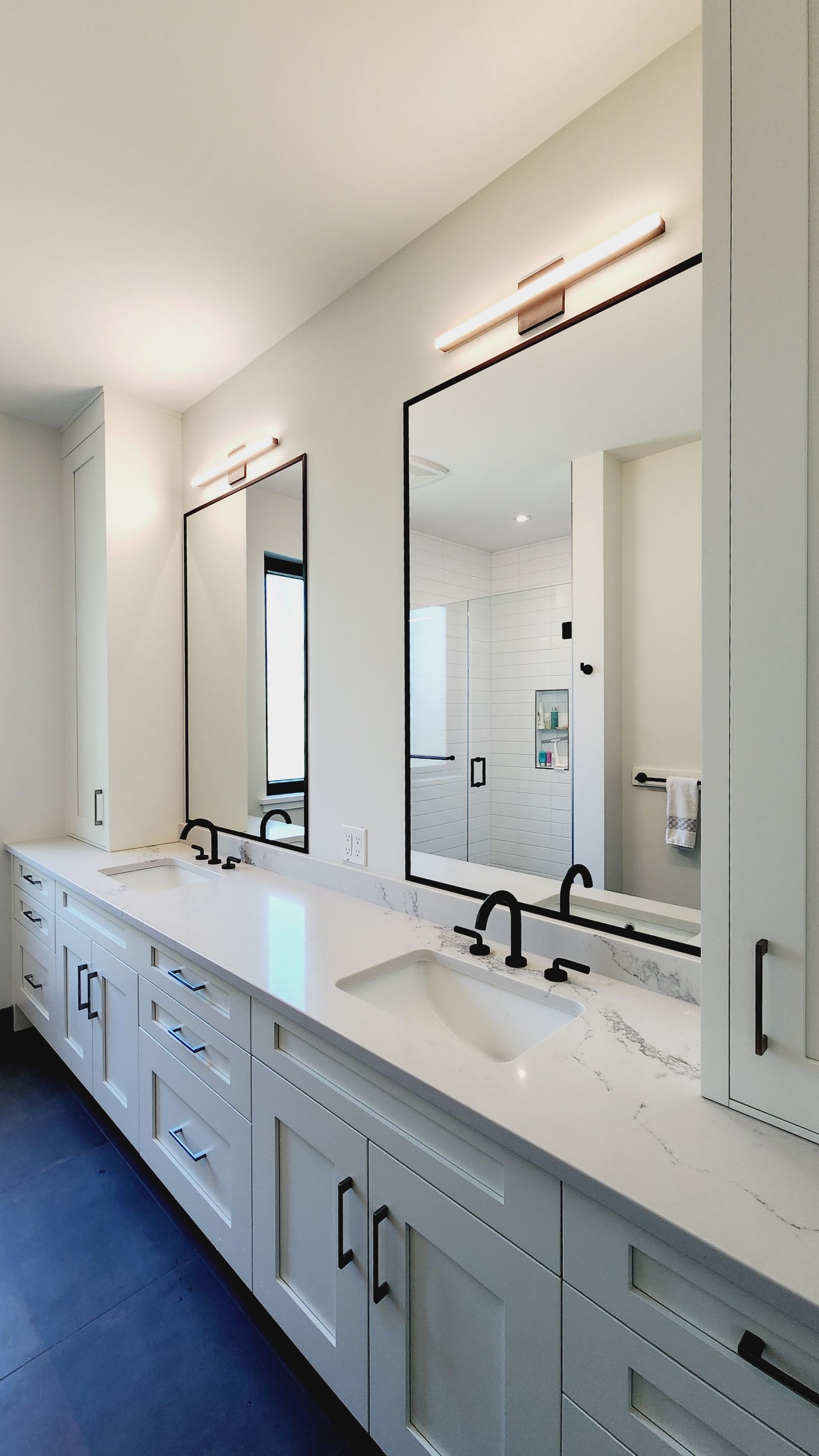 A bathroom with two sinks and two mirrors.
