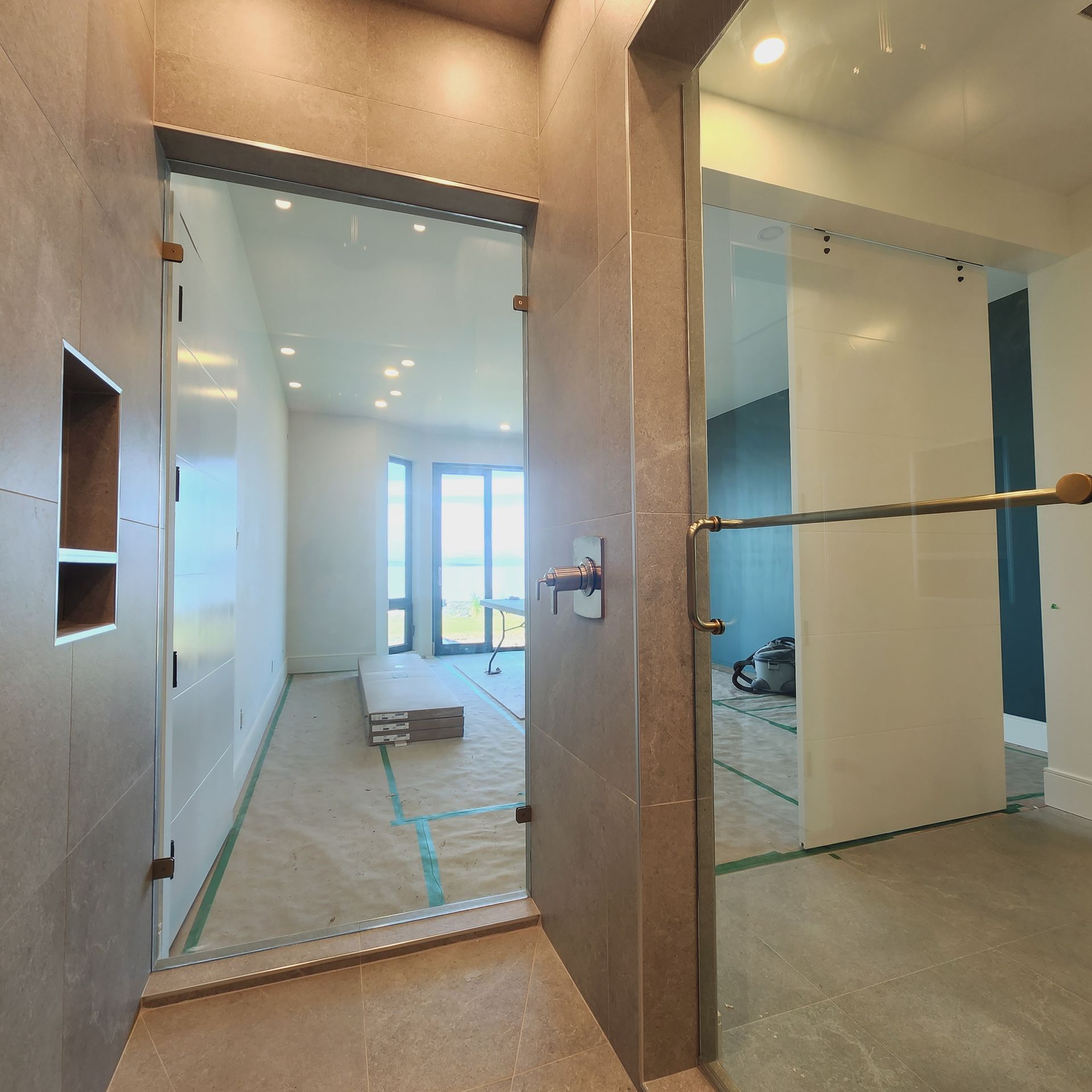 A room with a glass door leading to another room