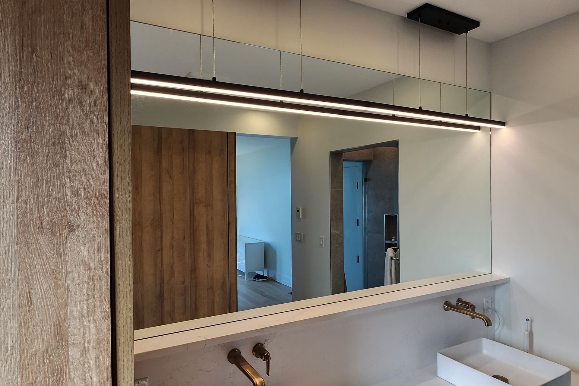 A bathroom with a large mirror and a sink