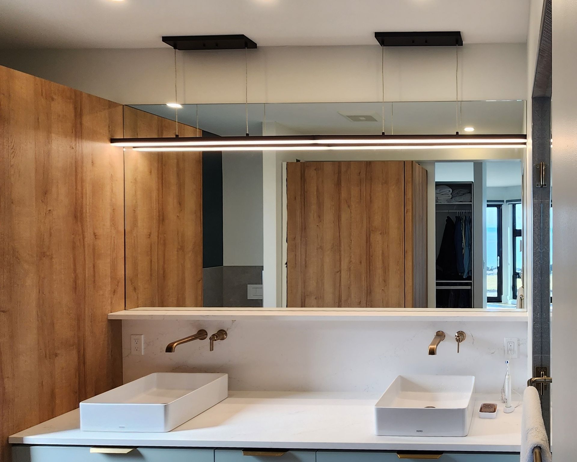 A bathroom with two sinks and a large mirror