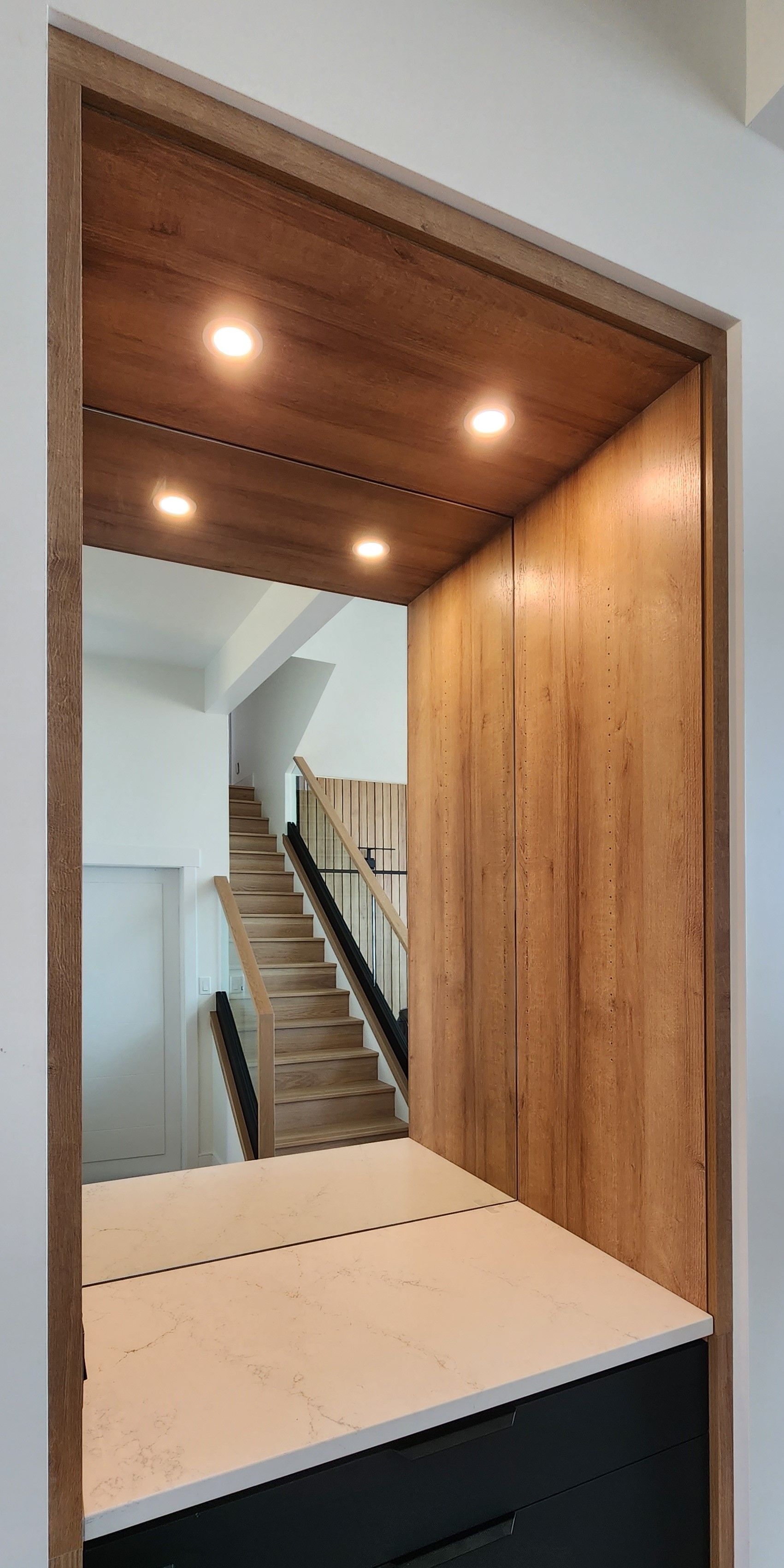 A staircase is visible through a doorway in a room.