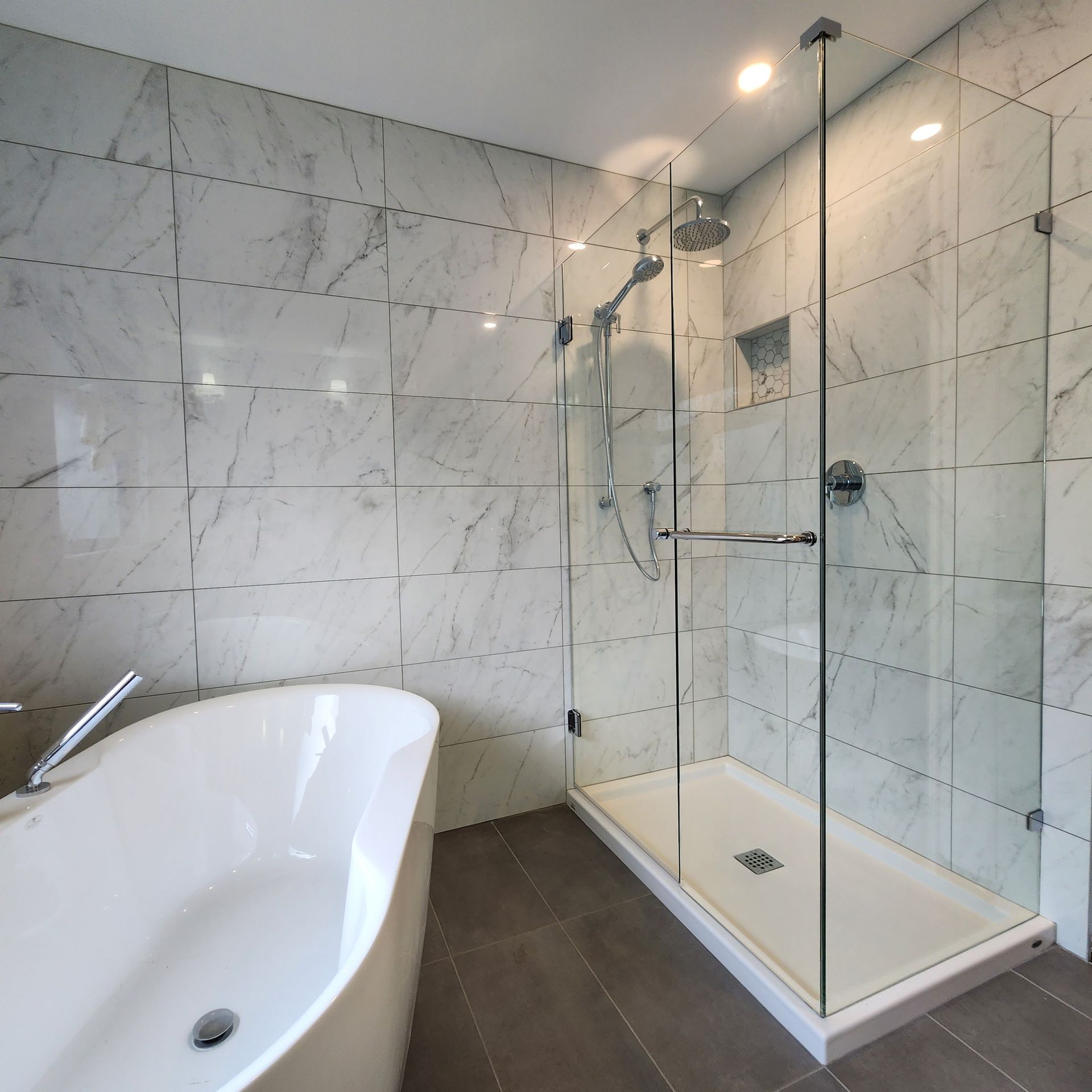 A bathroom with a bathtub and a walk in shower