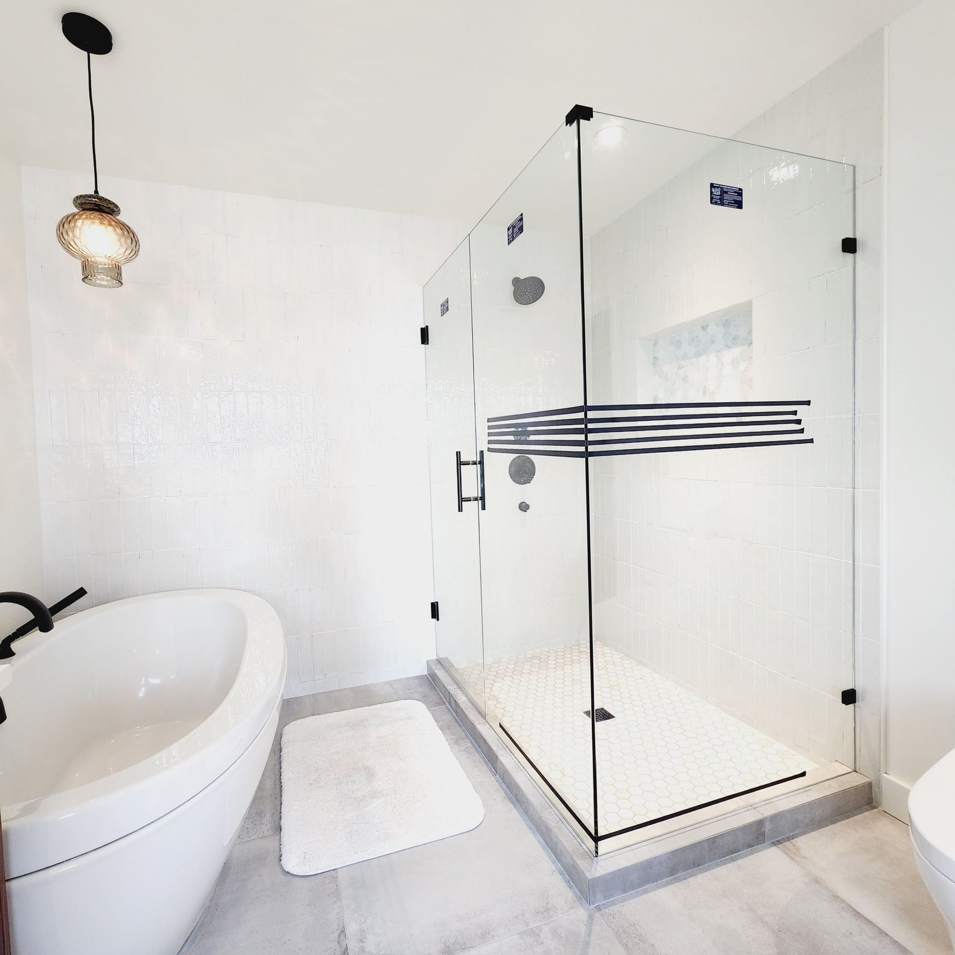 A bathroom with a bathtub and a walk in shower