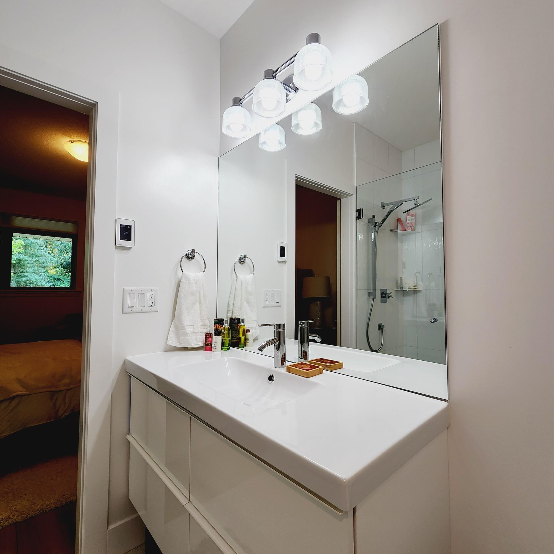 A bathroom with a sink and a large mirror