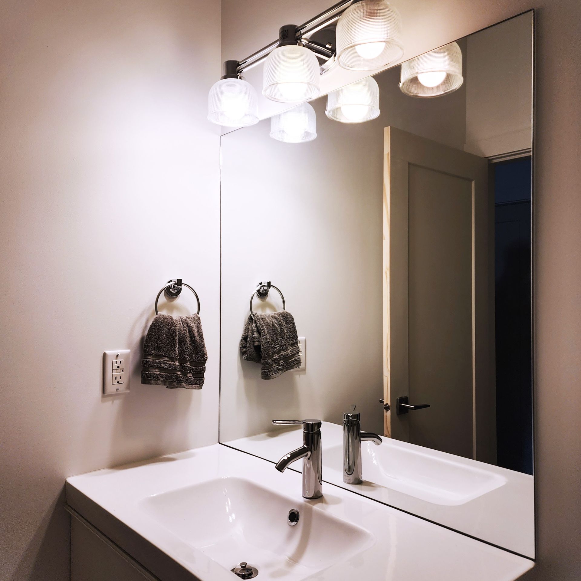 A bathroom with two sinks and a large mirror