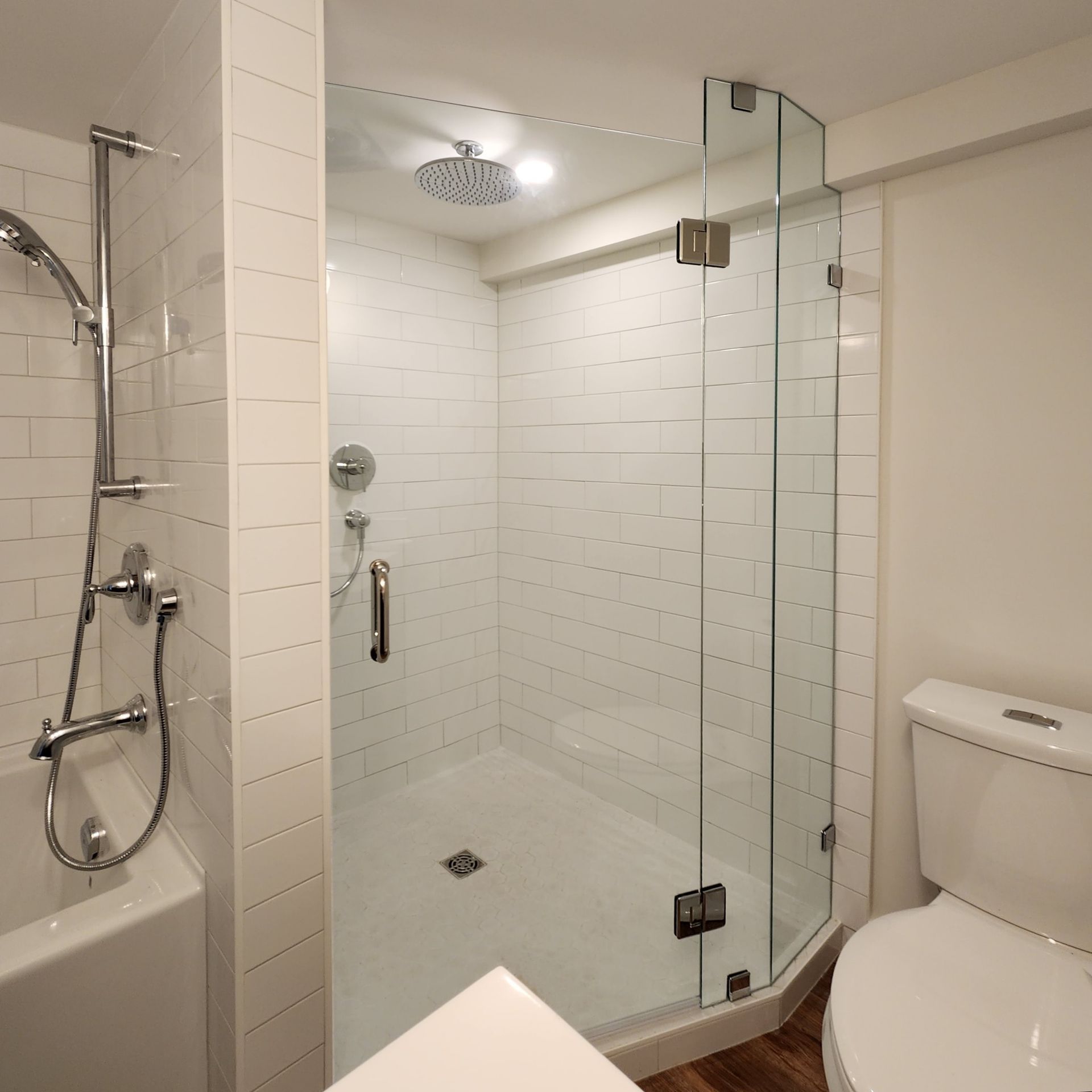 A bathroom with a walk in shower and a toilet