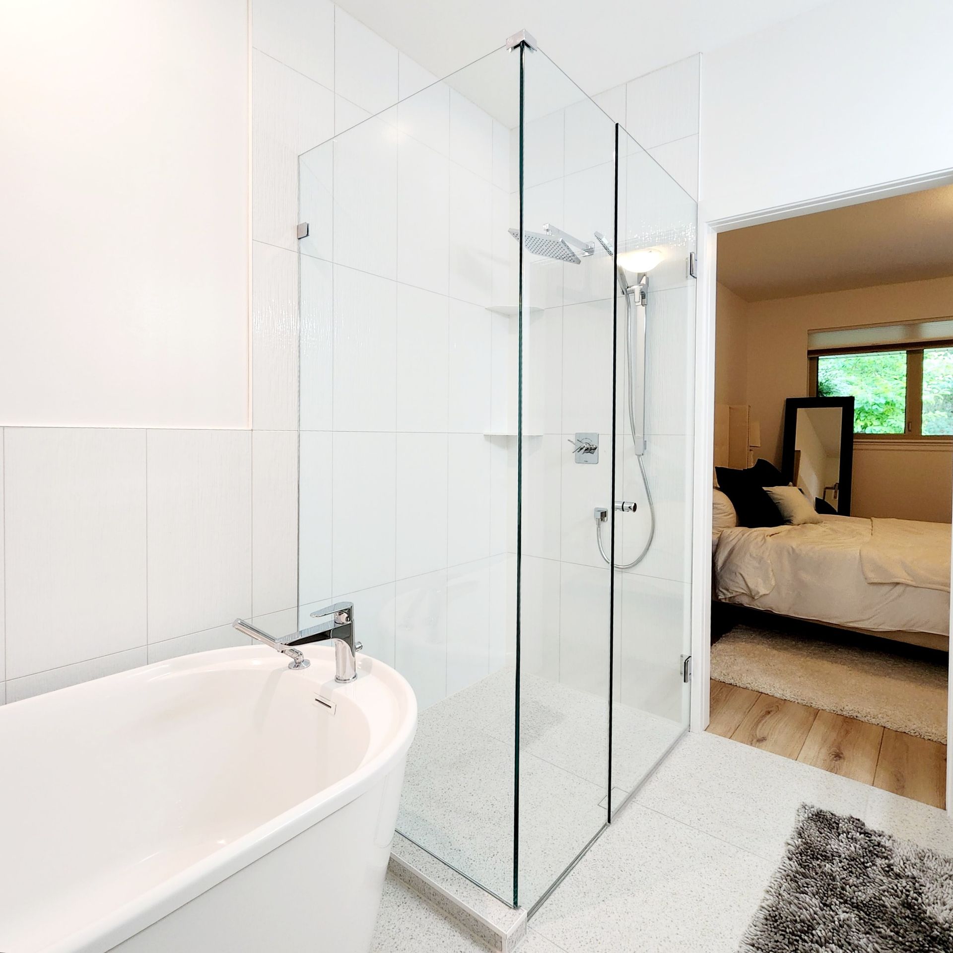 A bathroom with a bathtub and a walk in shower