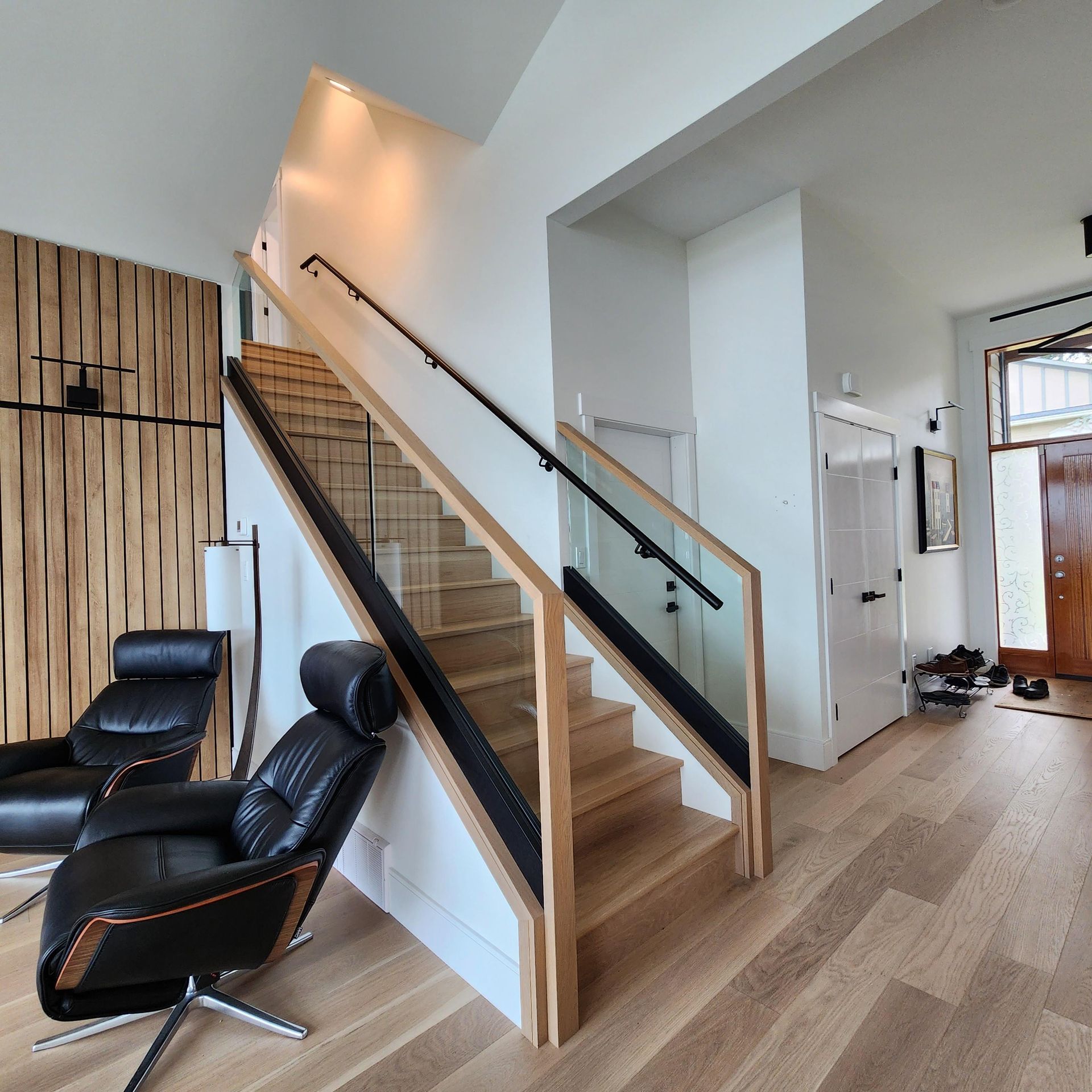 A living room with stairs leading up to the second floor