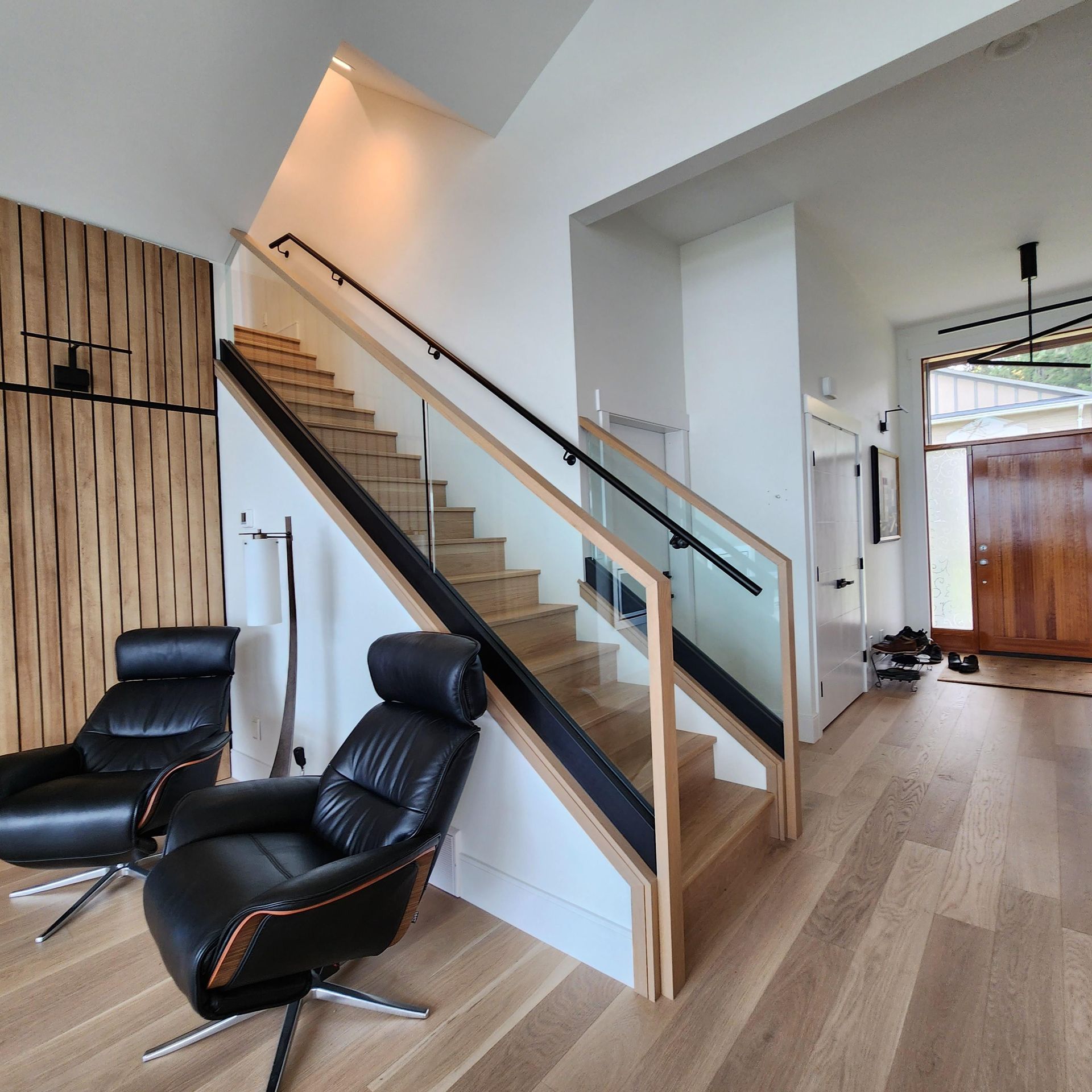 A living room with stairs leading up to the second floor