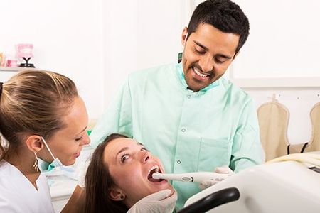 Dentist Examines The Oral Cavity — Man Getting His Teeth Checked in North Canton, OH