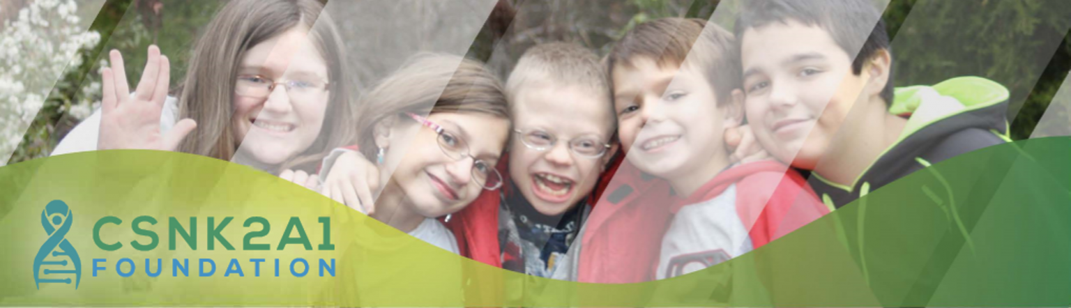 A group of children are posing for a picture with the csnk2ai foundation logo in the background.